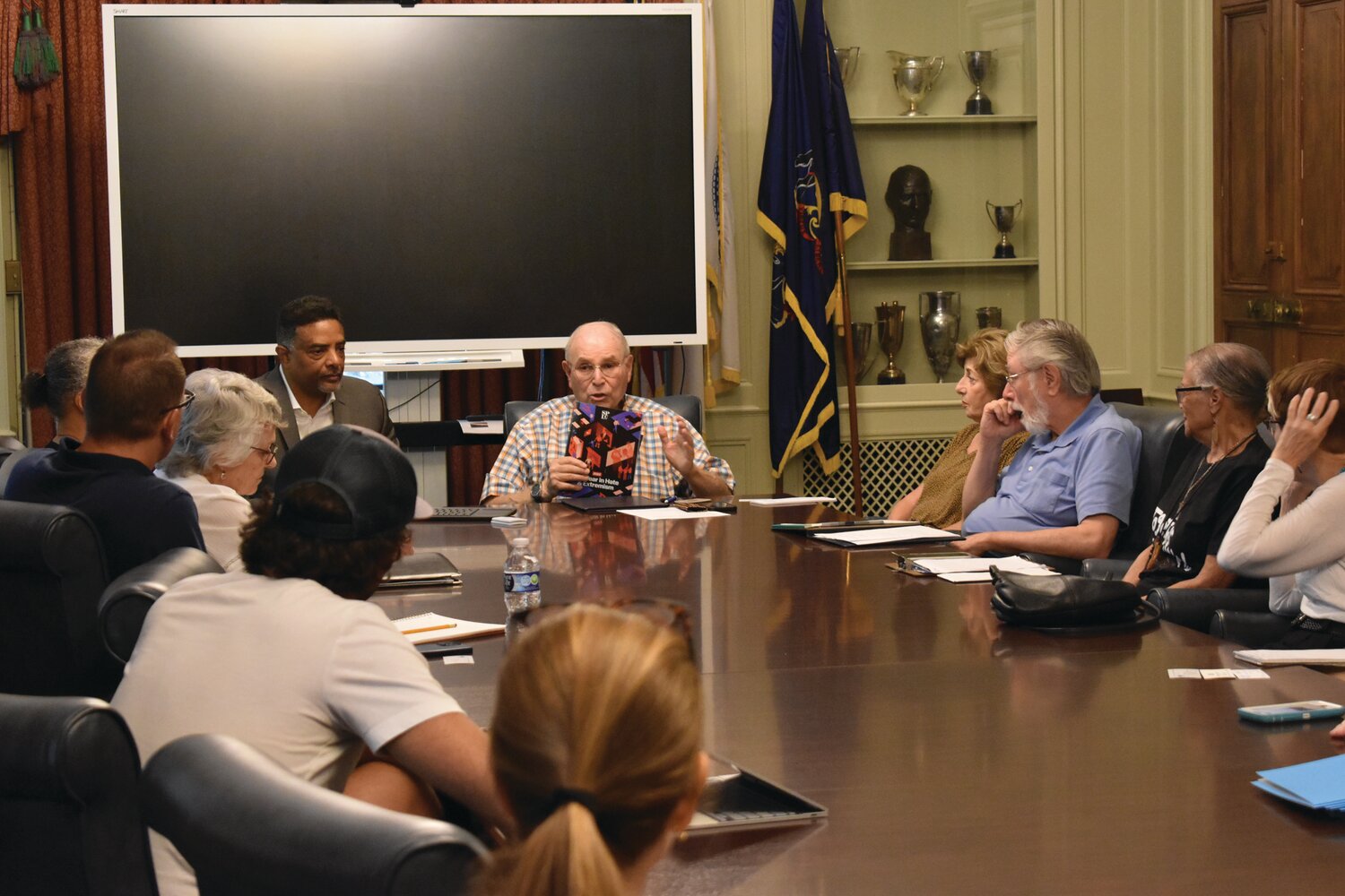 Bernie Hoffman, chair of the Bucks County Human Relations Council, shares a brochure about how to combat hate and extremism from the Southern Poverty Law Center at the Unity Meeting of Human Relations Commissions at Bucks County Community College July 26.