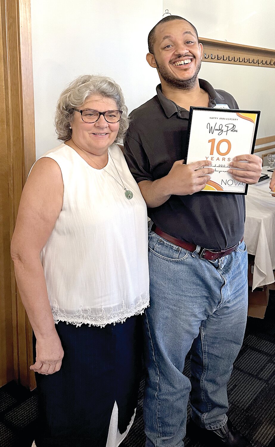 Maria White, NOVA Thrift Shop manager, poses with Woody Poles, a NOVA Thrift Shop volunteer, who was honored at the event for 10 years of service to the organization.