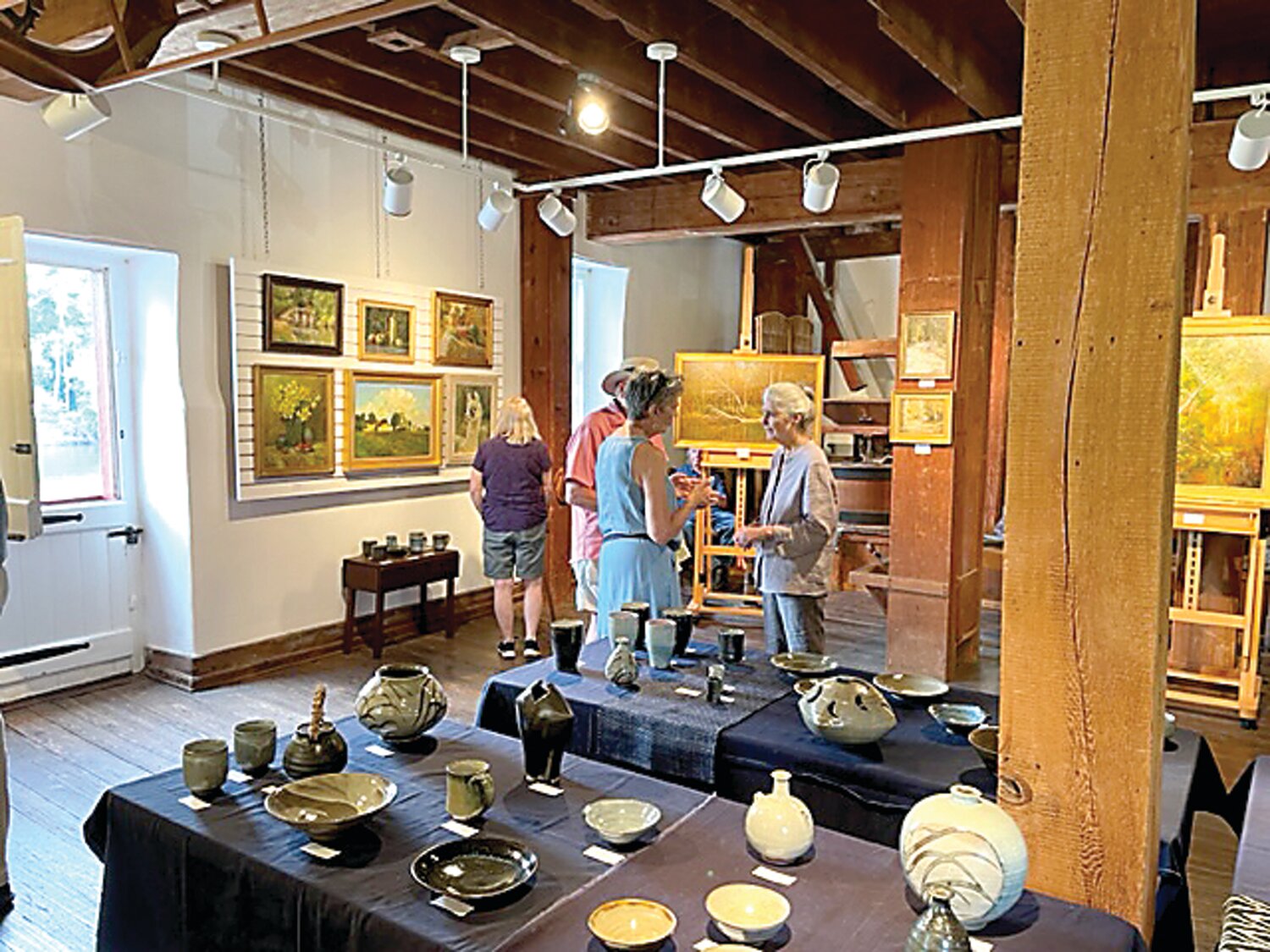 Visitors talk with artist Dot Bunn.