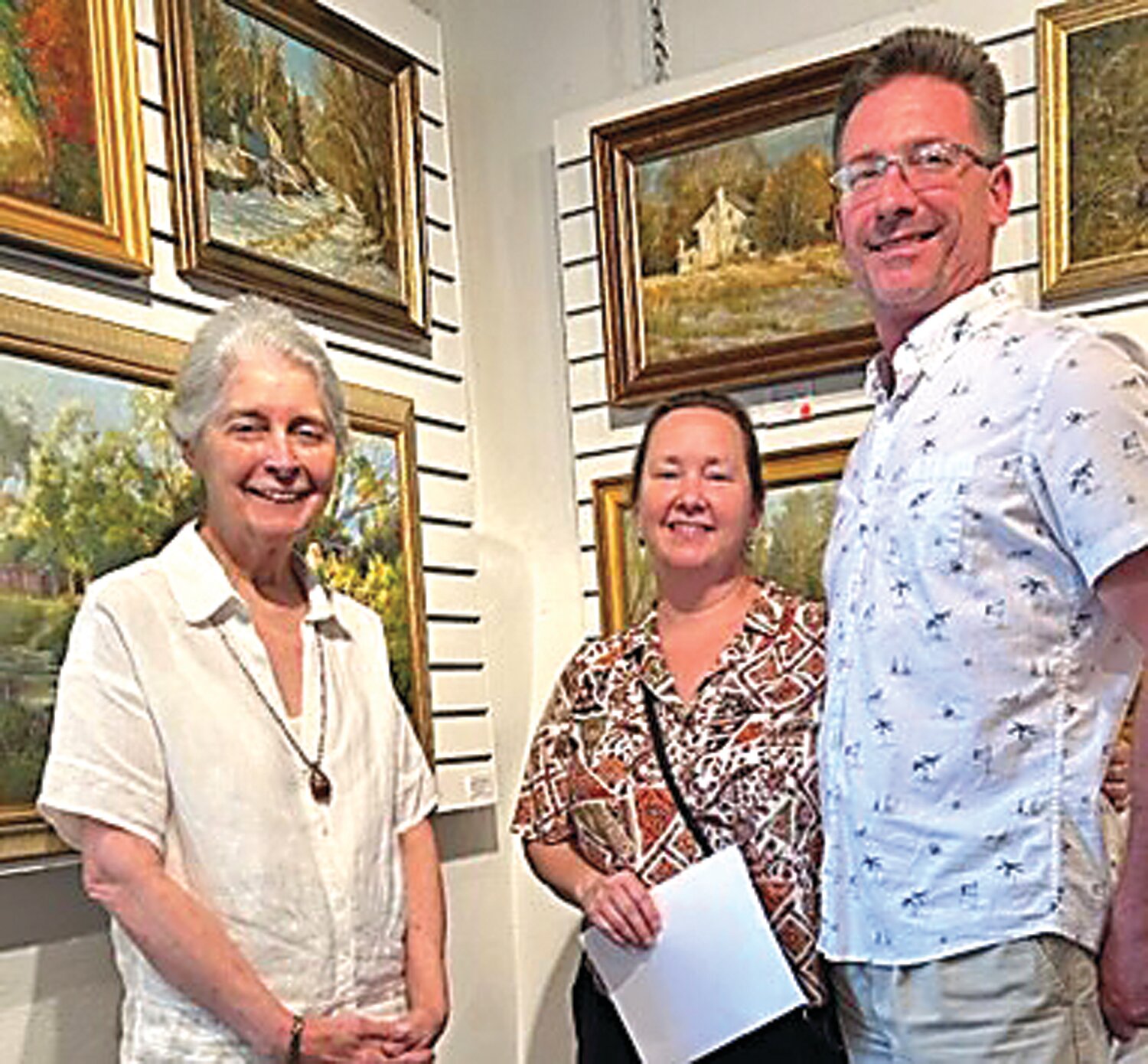 Dot Bunn, Sharon Martin and her husband with their new acquisition, “White House in Snow.”