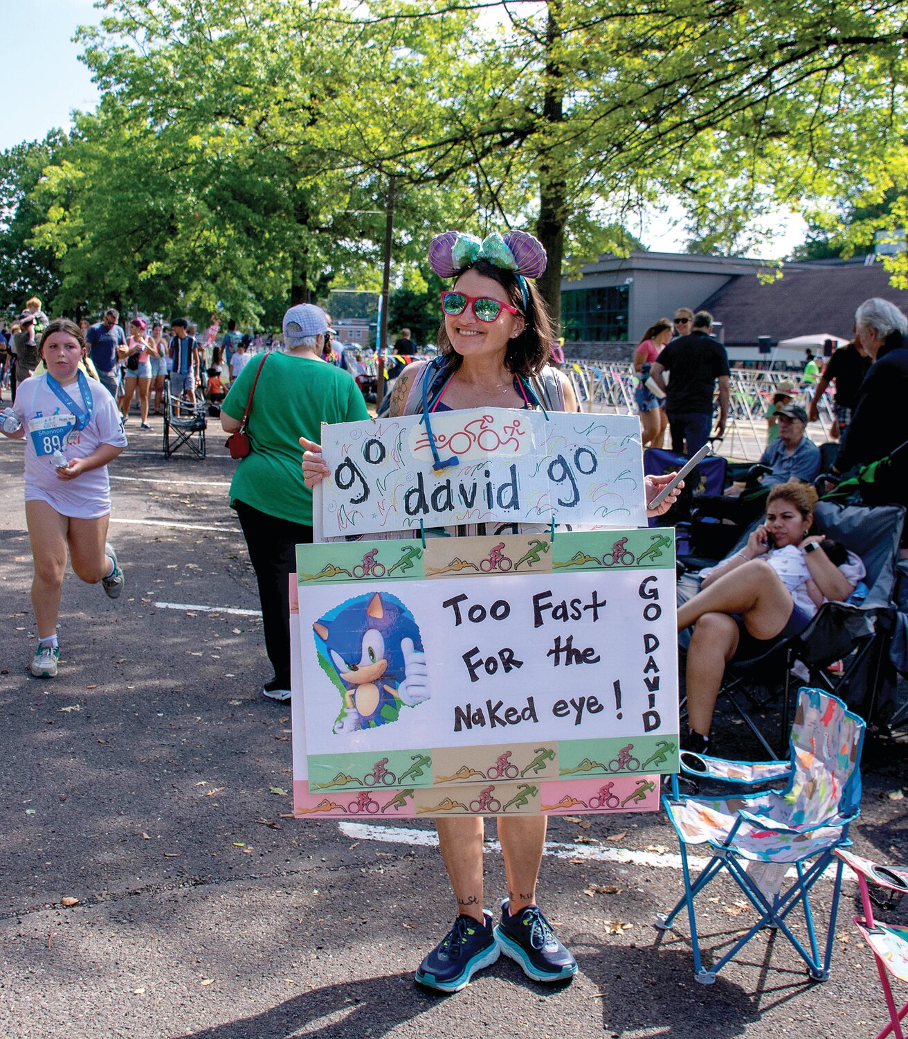 Amanda Jaxheiner looks to give her nephew, David Jaxheiner. a jolt of sonic speed with her signs.