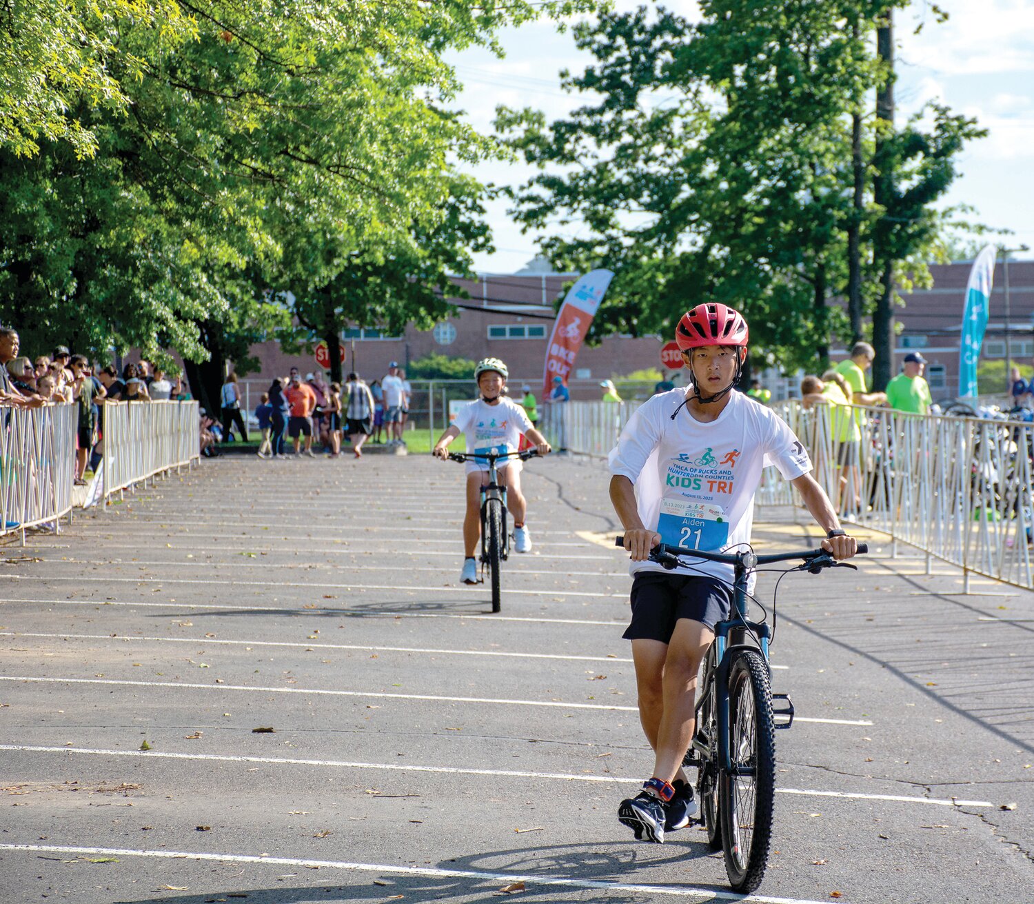 Aiden Lee cruises to the end of the bicycle leg of the YMCA Kids Triathlon.