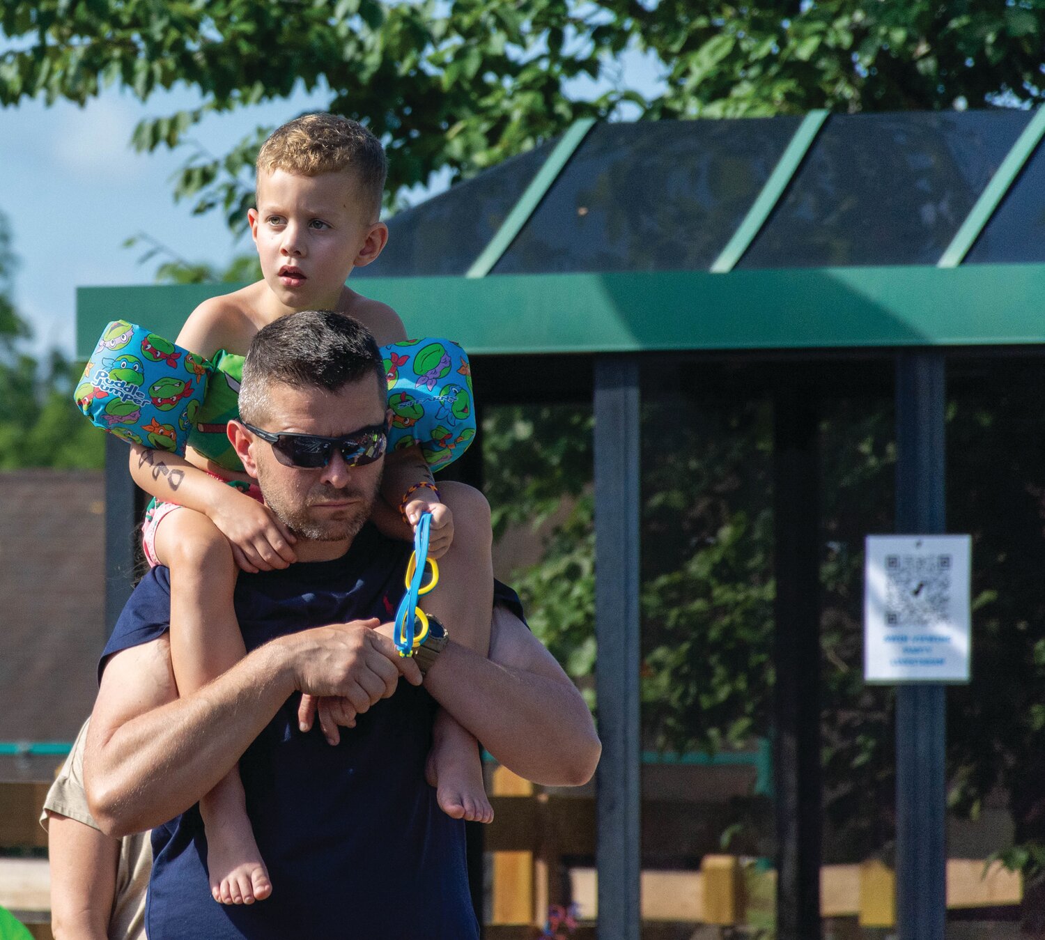 Mike Szewczyk gives his son, Nikolas, a better view of the action.