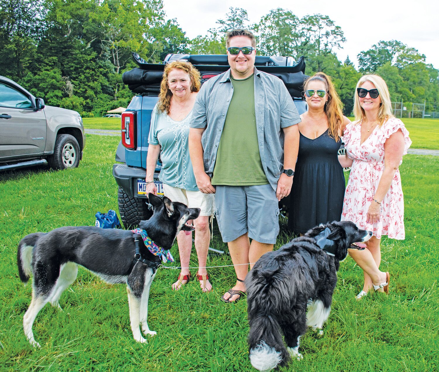 Chris Waegerle, Max Waegerle, Laurie Picciotti and Lorden Malloy stand with Koda, left, and Dingus.