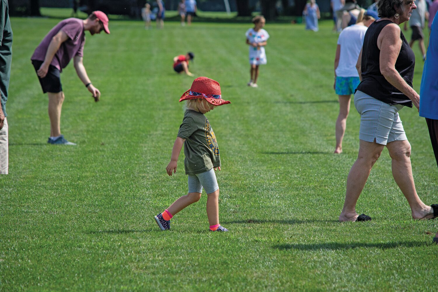 Spectators take to the field at halftime for some divot stomping to replace pieces of turf kicked up by the horses during the game.