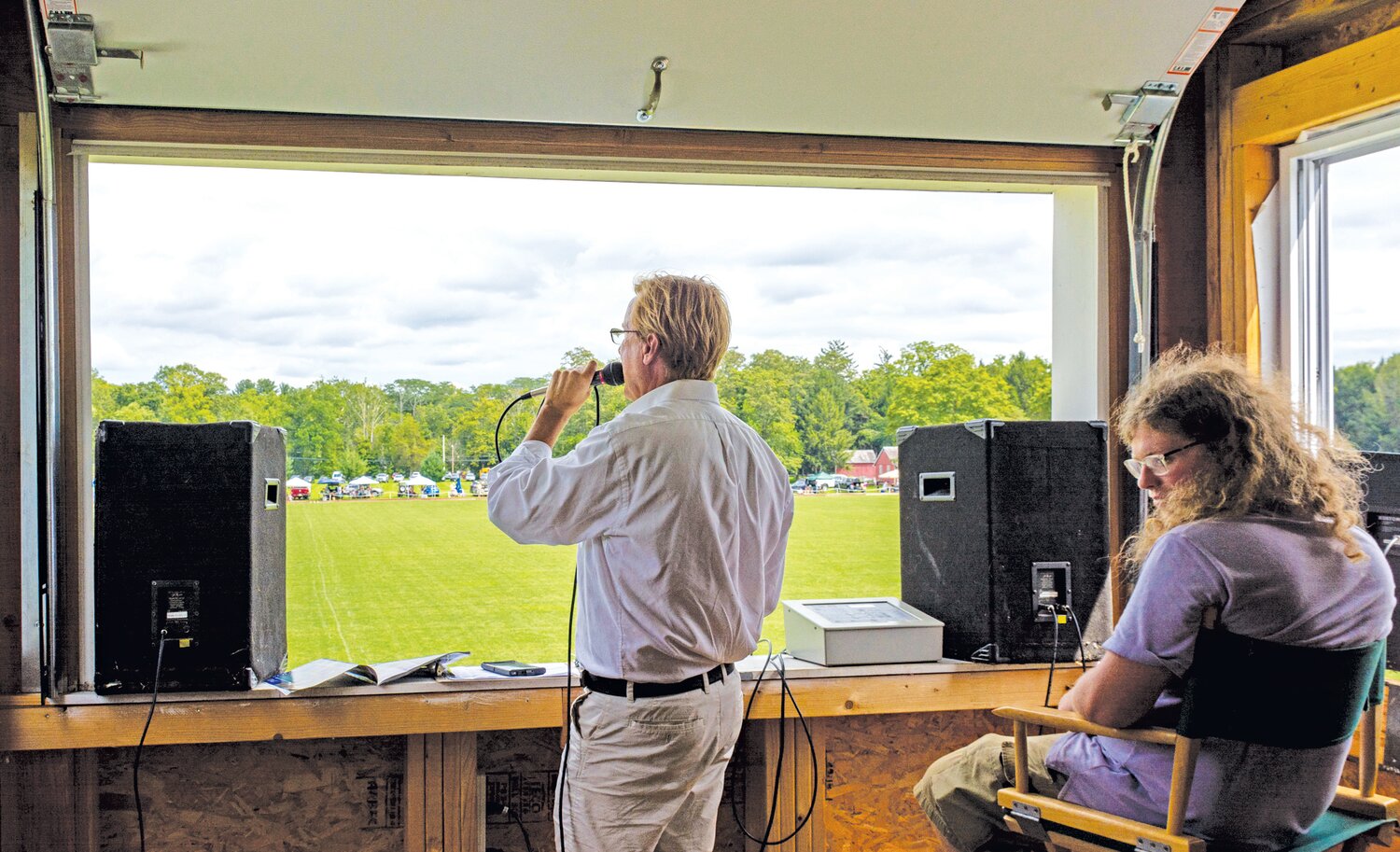 Joe Gantert calls the action from the booth, while Owen Halliday looks on.