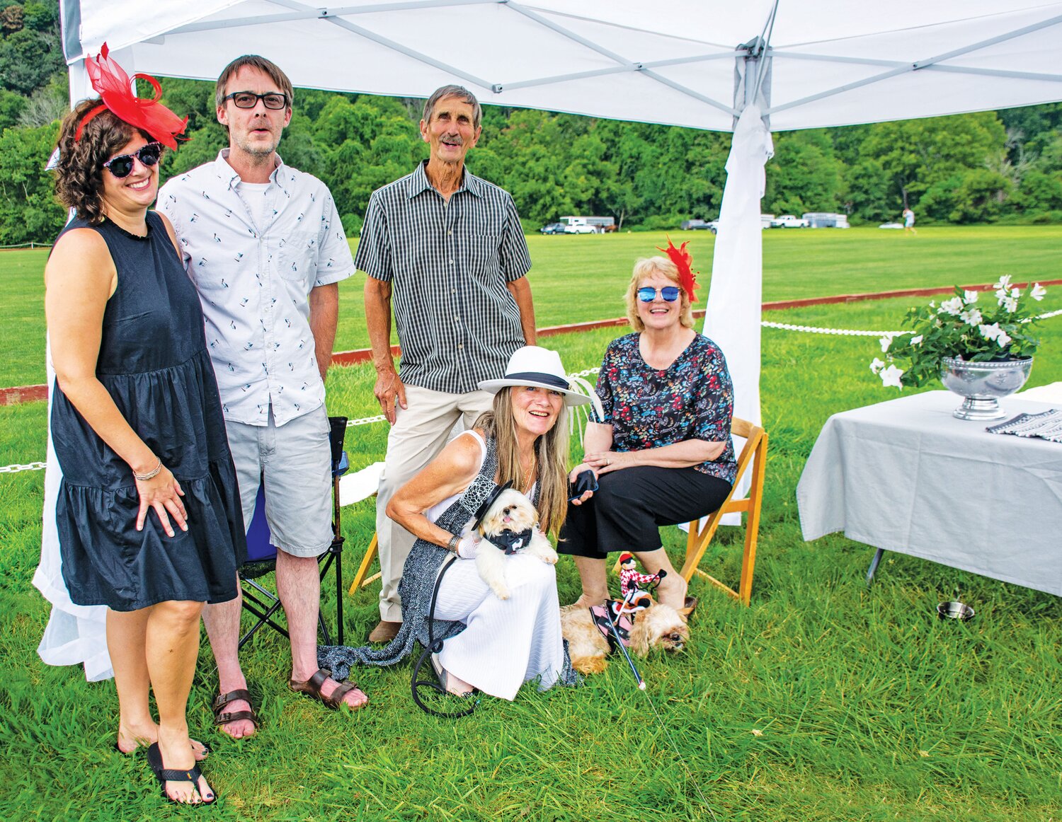 Melissa Macarro, Kris Murphy, Glenn Shade, Celeste DaShiell and Gwen Macarro pose with Bella, whose jockey costume took first place in the costume contest, and Dante, who wore a tuxedo to the game.