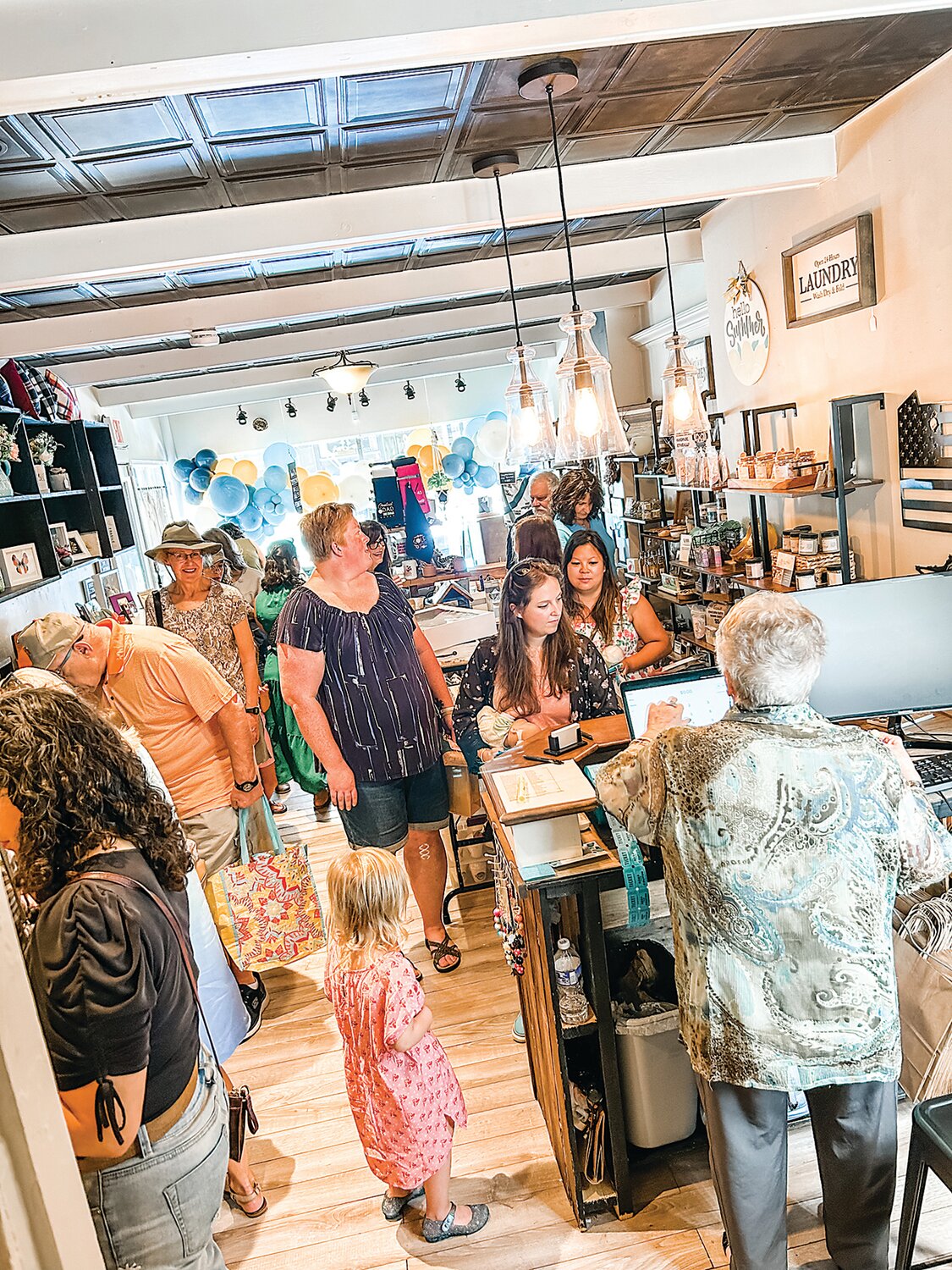 Shoppers look around during an opening event at Makers Off Main.