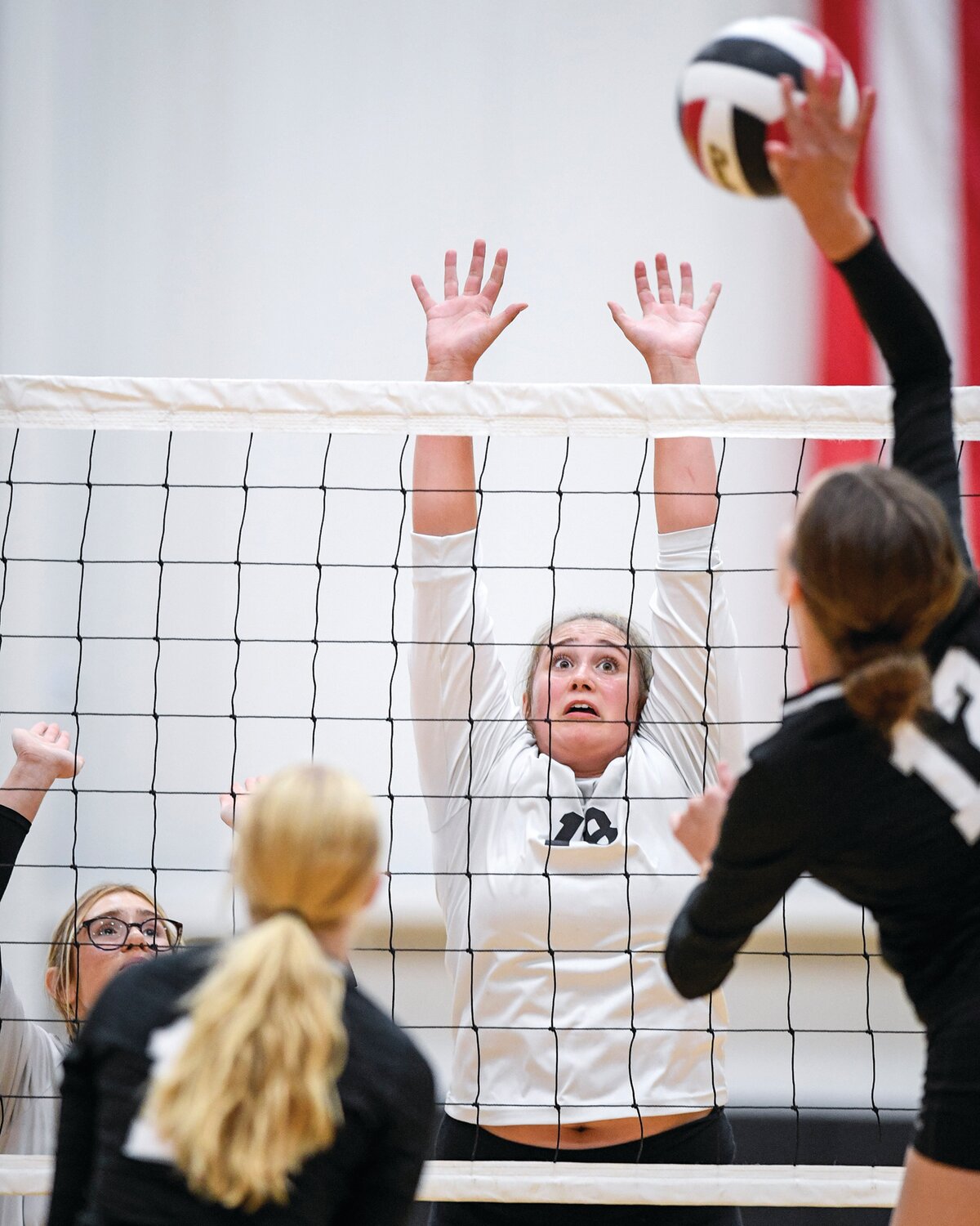 Plumstead Christian’s Maddie Shackelford looks to block a spike from Faith Christian’s Payton Robillard.