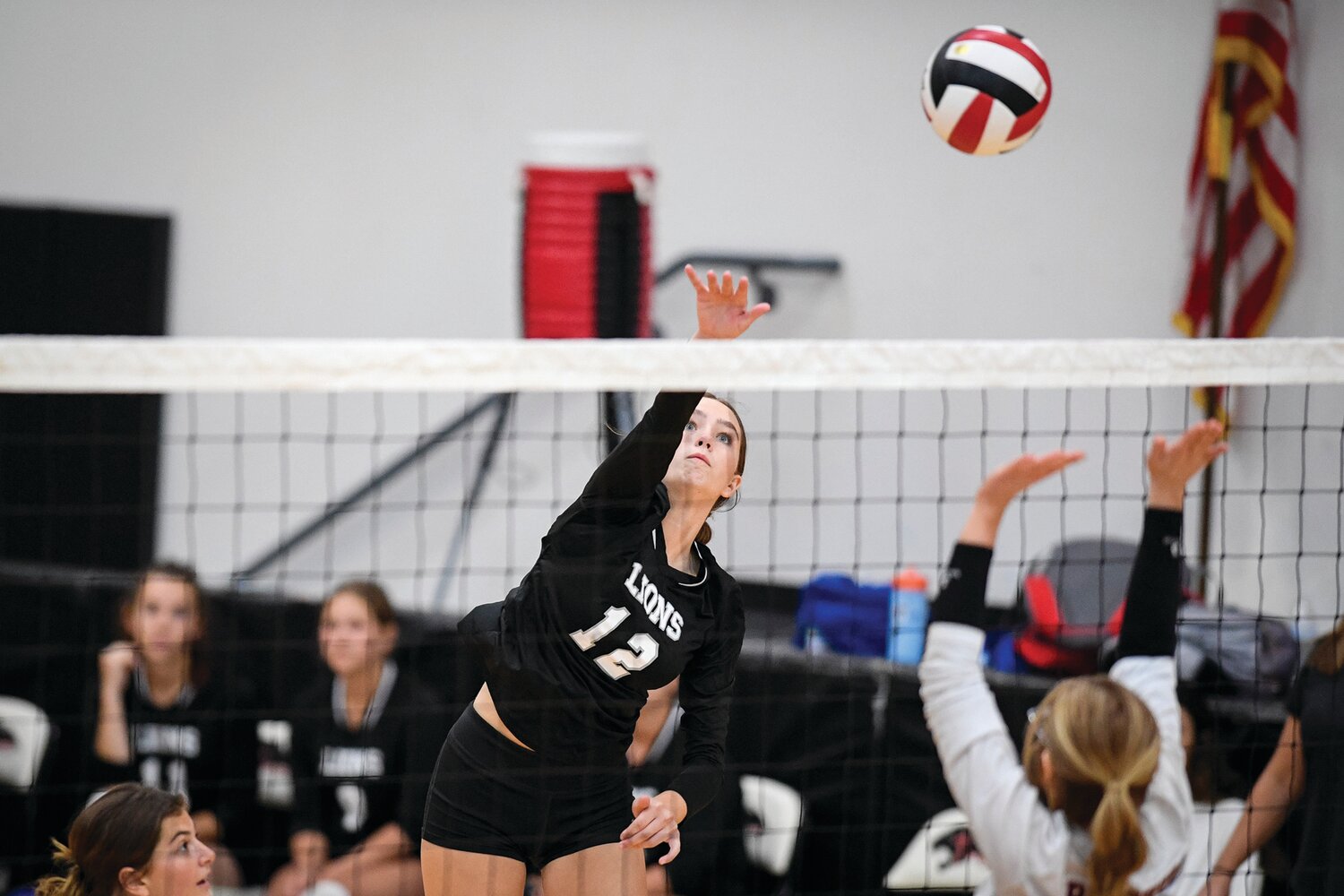 Faith Christian’s Payton Robillard sends a kill during the Lions’ three-game sweep.