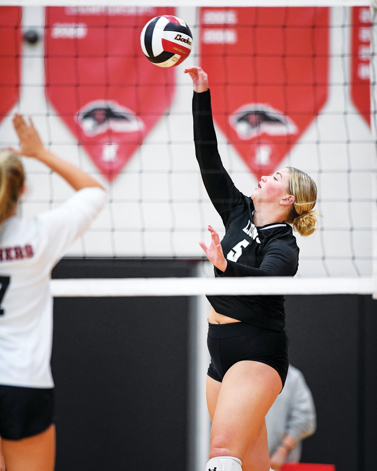 Faith Christian’s Kinsey Reptsik slams a kill during the first match.