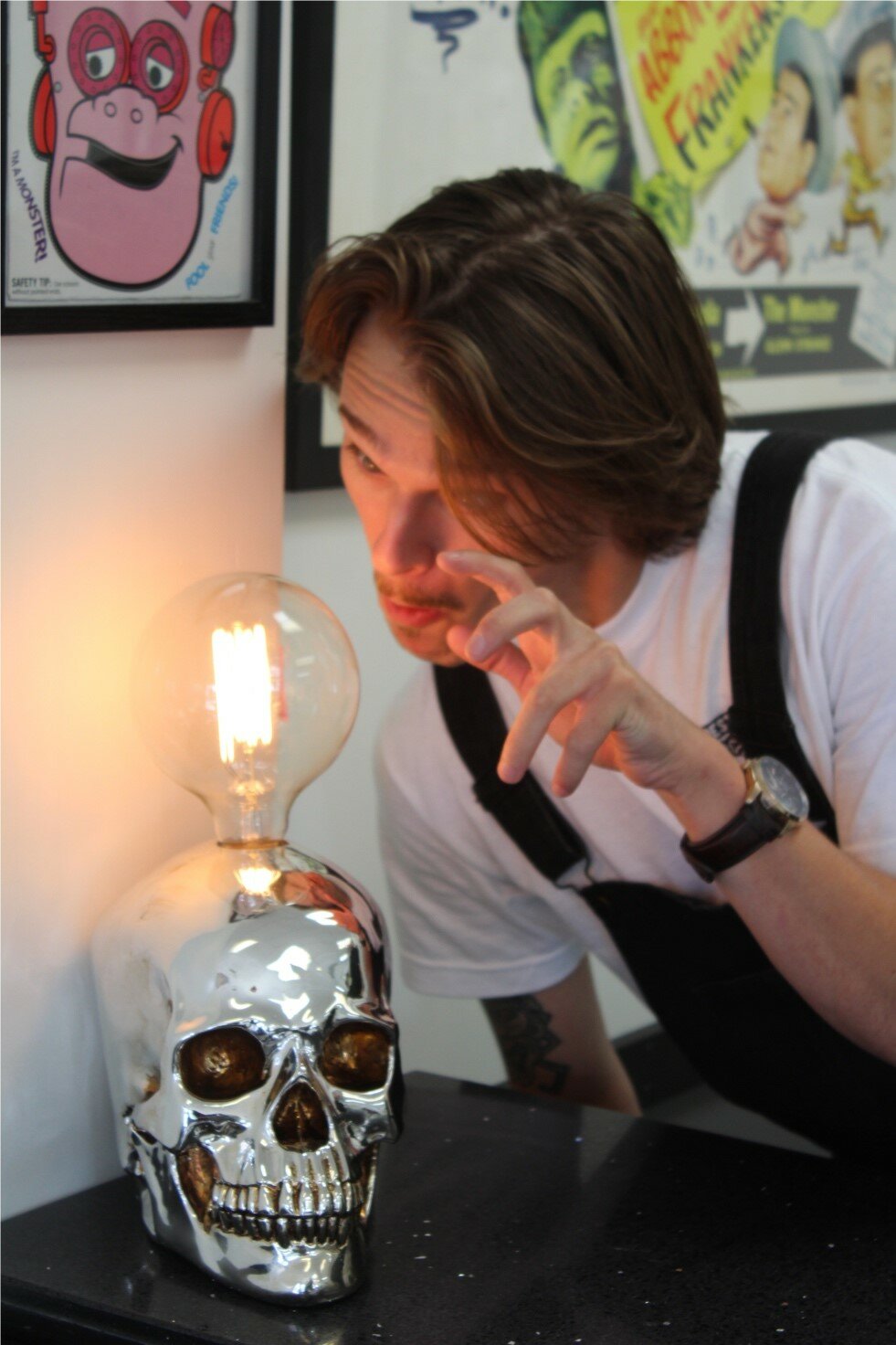 Luke Pomper poses with a skull. Happily Haunted Barbershop in Doylestown is the bright idea of Pomper’s friend Diehl Mollica.