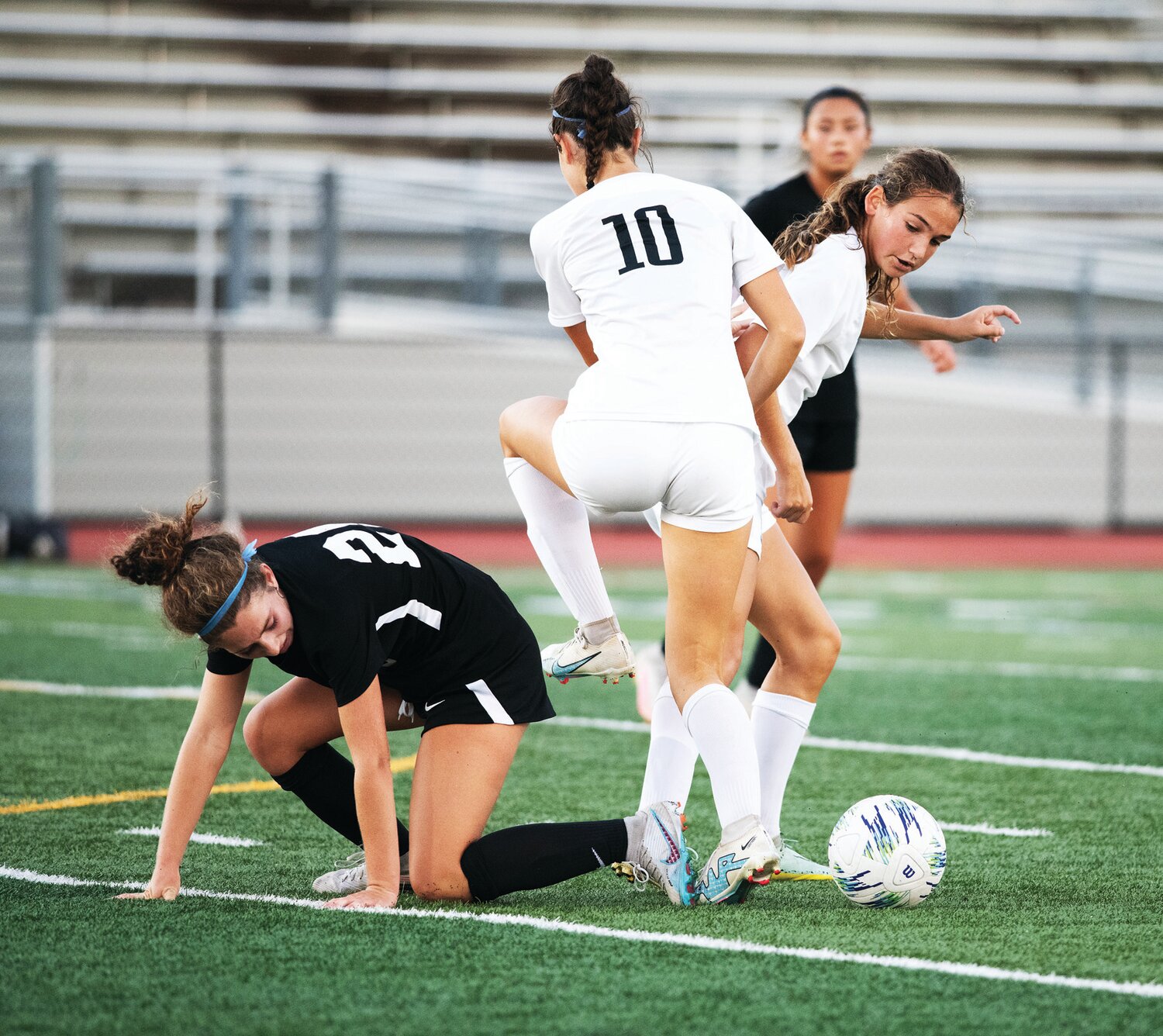 Pennridge’s Molly Fannon gets tangled up with CB South’s Abbie Bass and a Titans teammate.