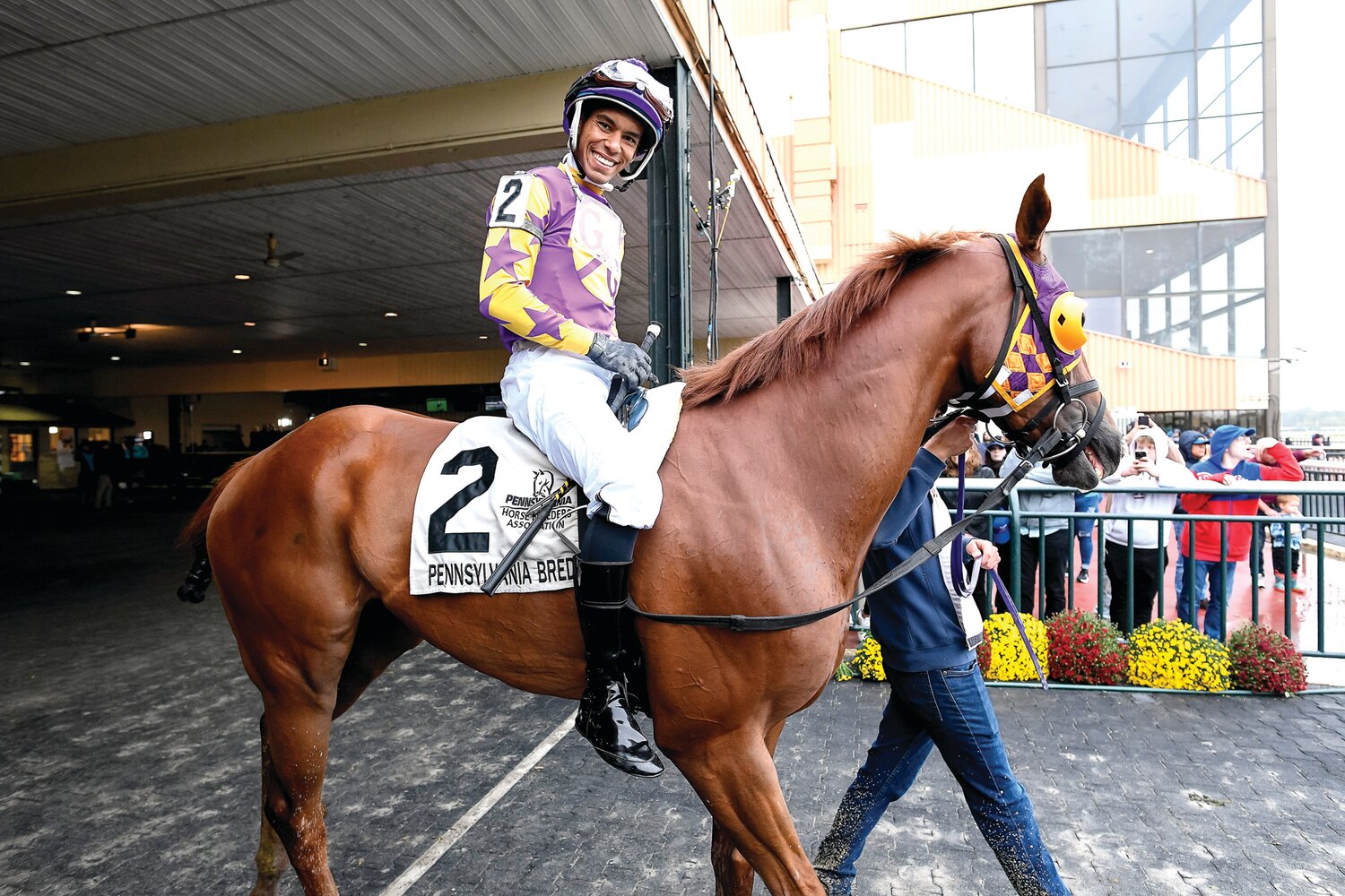 Jockey Ruben Silvera and Market Maven are led out to the track before race No. 9.