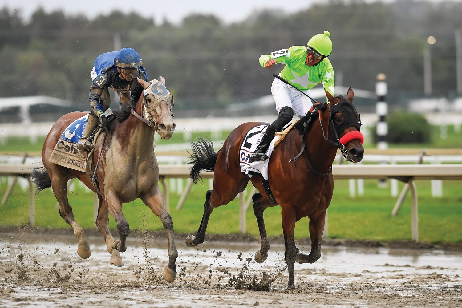 Edwin Maldonado, aboard Ceiling Crusher, pumps his fist after winning the Cotillion Stakes in front of Pretty Mischievous, ridden by jockey Tyler Gaffalione.