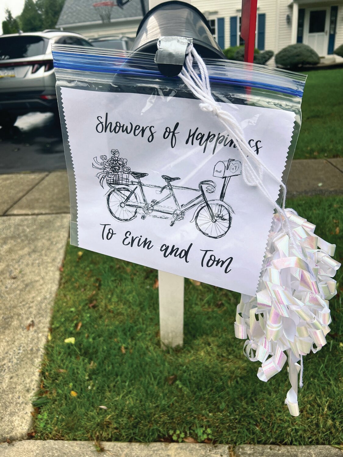 Festive decorations brightened  the dreariness of a recent Monday in Warrington Hunt, as the neighborhood celebrated its mail carrier.