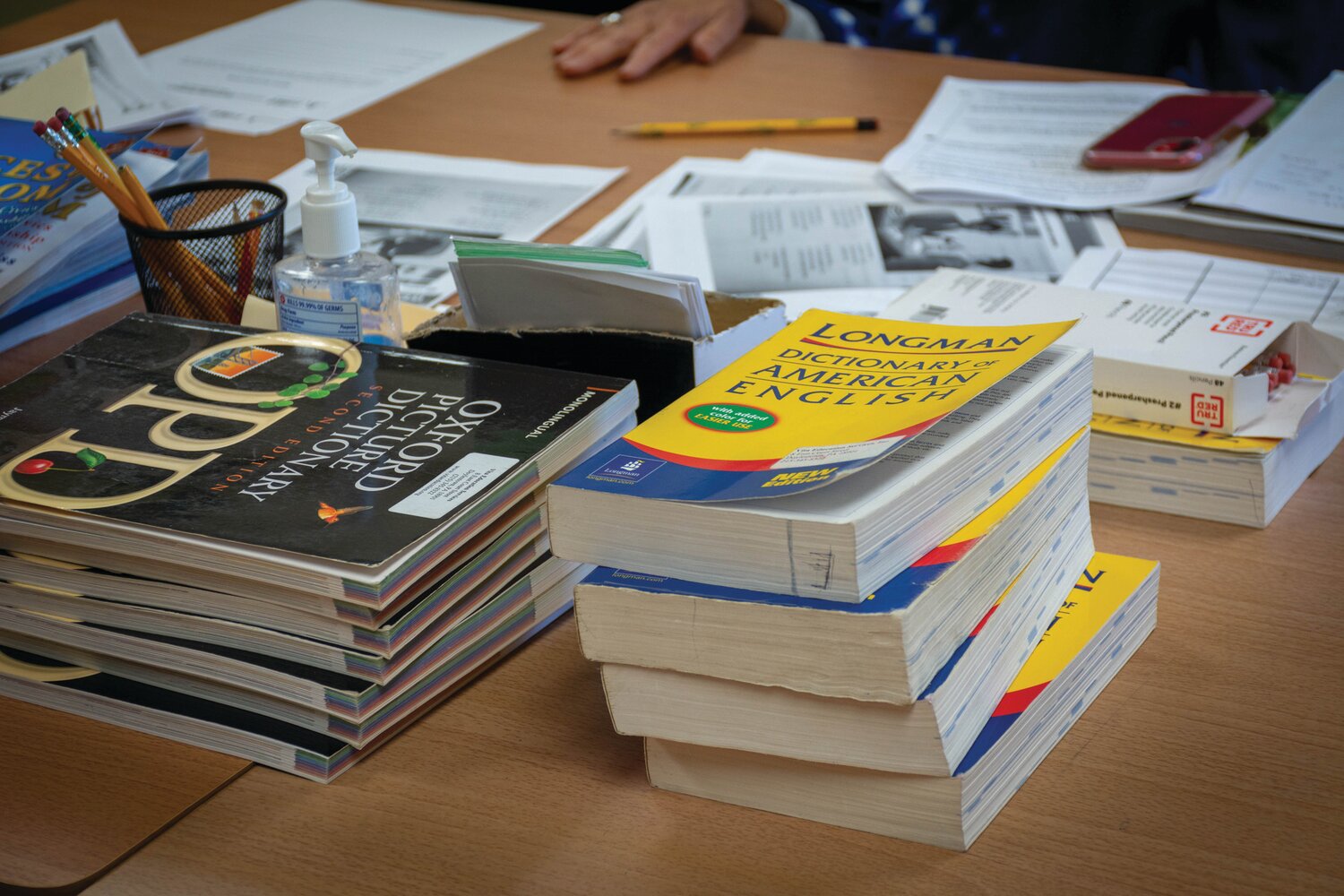 English dictionaries sit in stacks on the table at Vita’s Doylestown site. They come in handy during ESL classes the nonprofit provides.