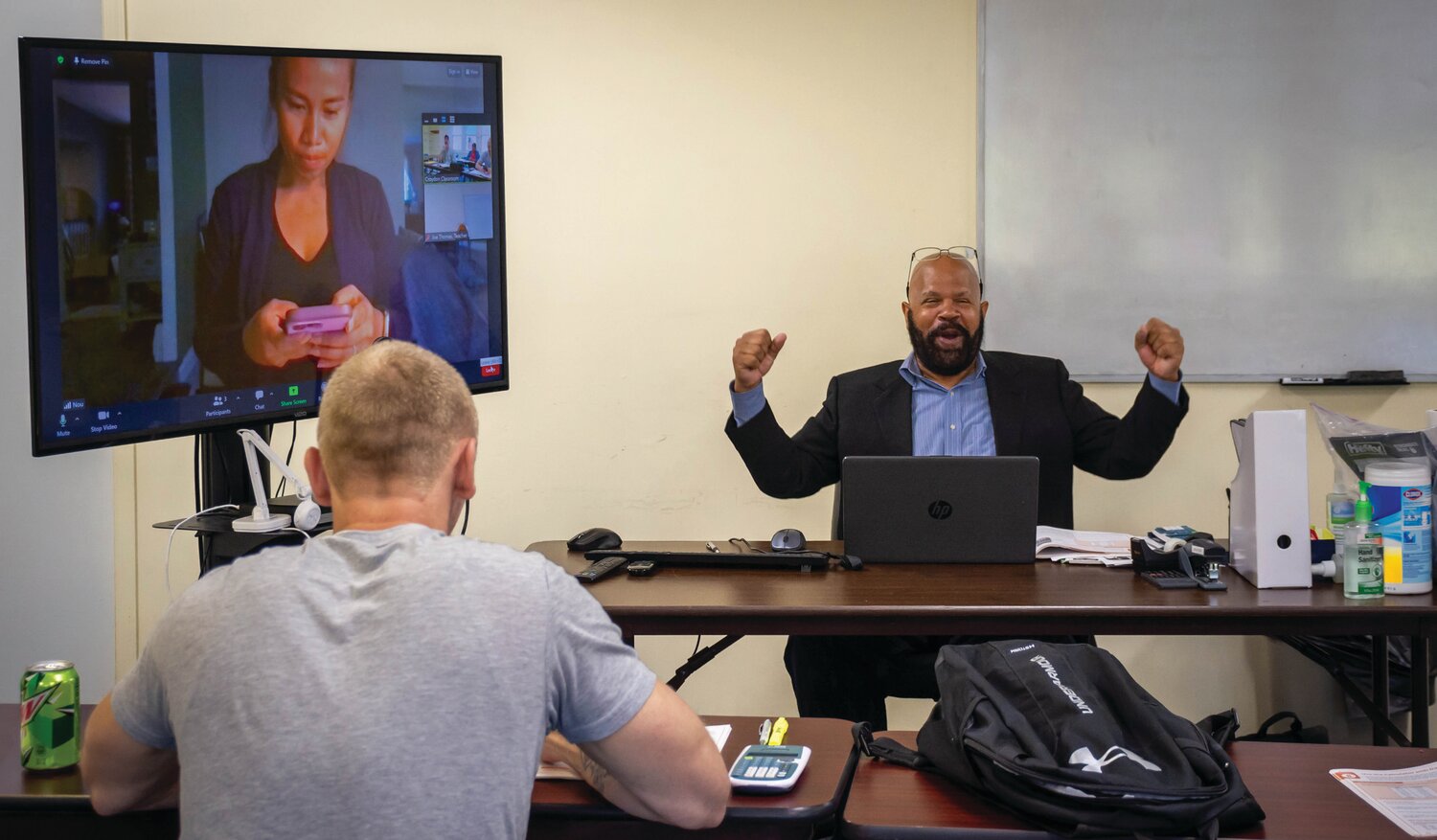 Teacher Joseph Thomas gets animated during a hybrid in-person and virtual session at Vita’s site in Croydon.