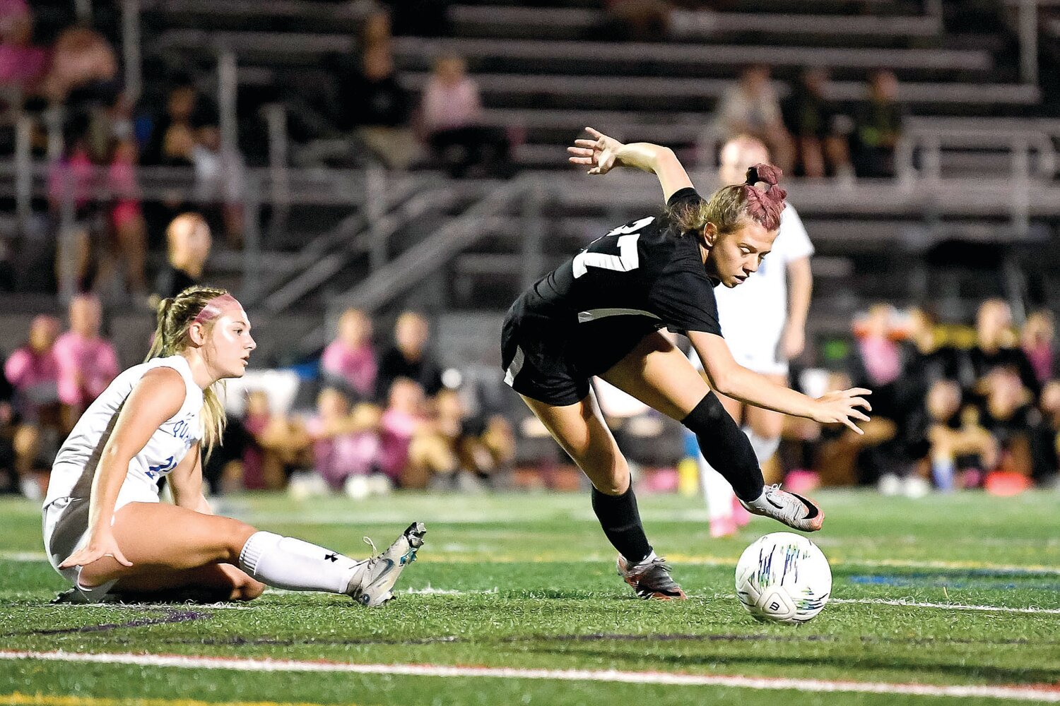 Pennridge’s Bryn Constanzer battles for a loose ball to get off a shot in front of Quakertown’s Carlee Roesener in the second half of Monday’s game.