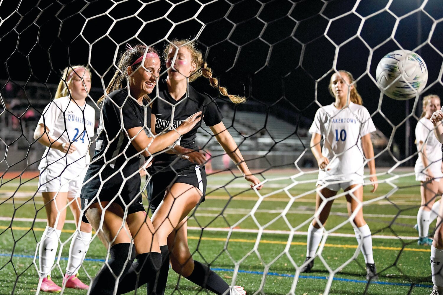 Pennridge’s Addy Mills, left, celebrates the first goal of the game by Anna Croyle, right.