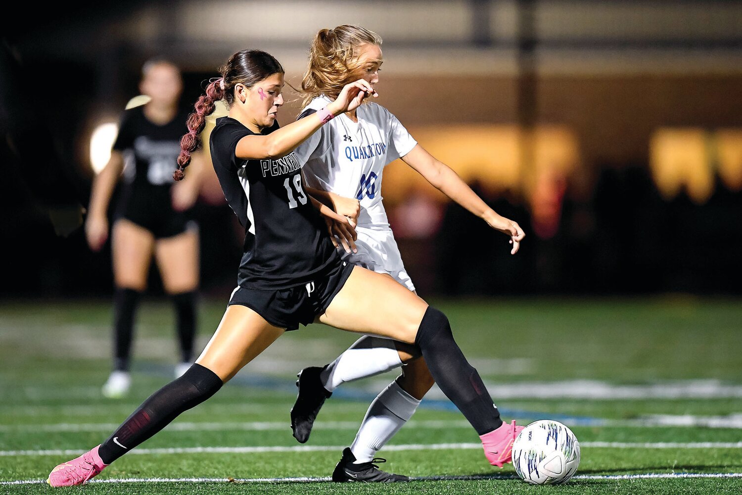 Pennridge’s Meredith Blannett beats Quakertown’s Taylor Kletzing to a loose ball in the first half.