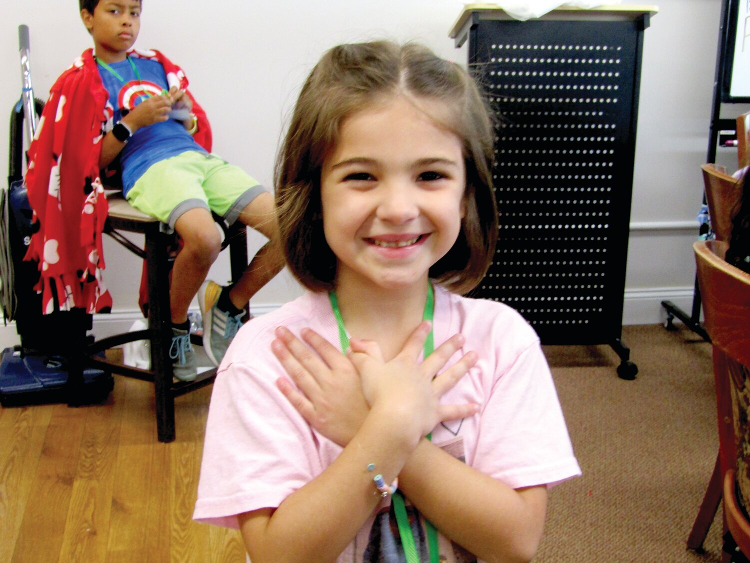 A camper bears a wide smile during her time at Hands Holding Hearts’ camp.