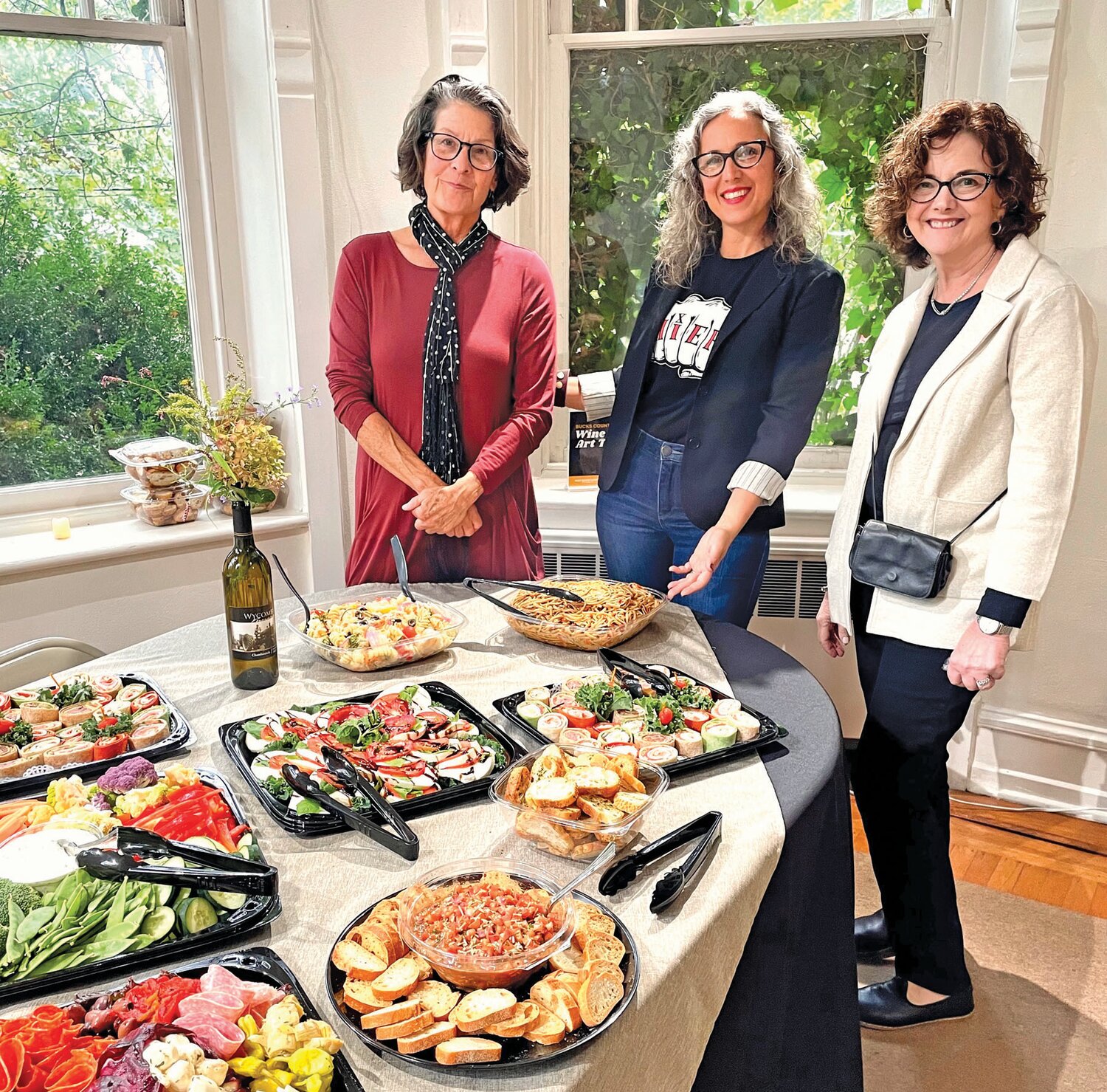 Arts & Cultural Council board members, from left, Hayden Saunier, Ashara Shapiro and Robbin Farr helped host the closing reception for the Wine & Art Trail Exhibition.