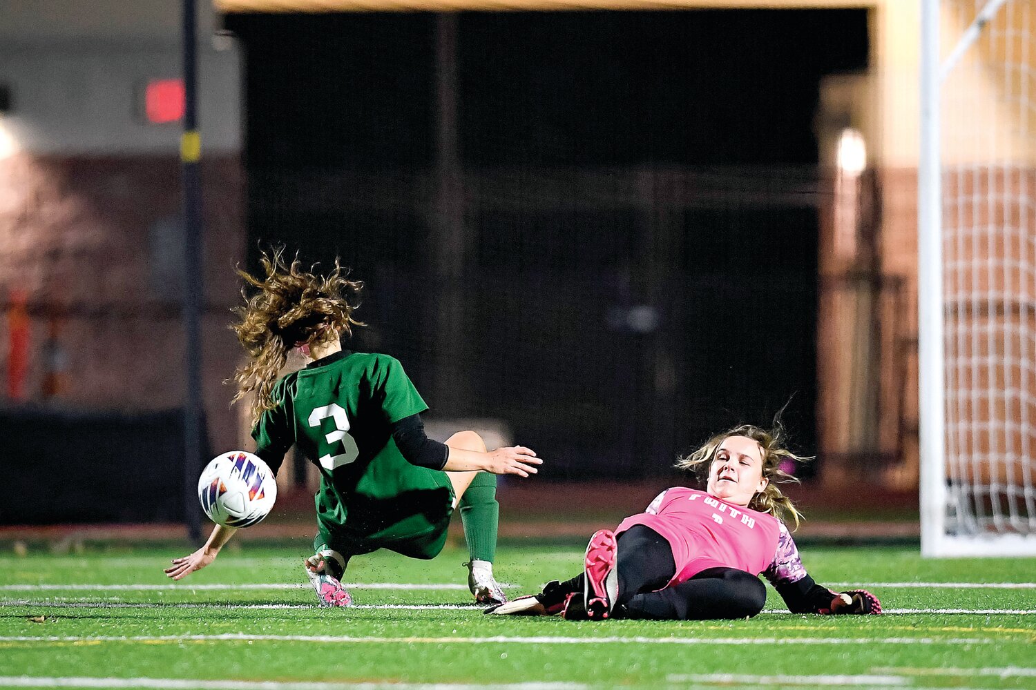 Dock Mennonite’s Ashley Lapp has her shot attempt kicked away by a sliding Faith Christian goalie Barbie Preston.