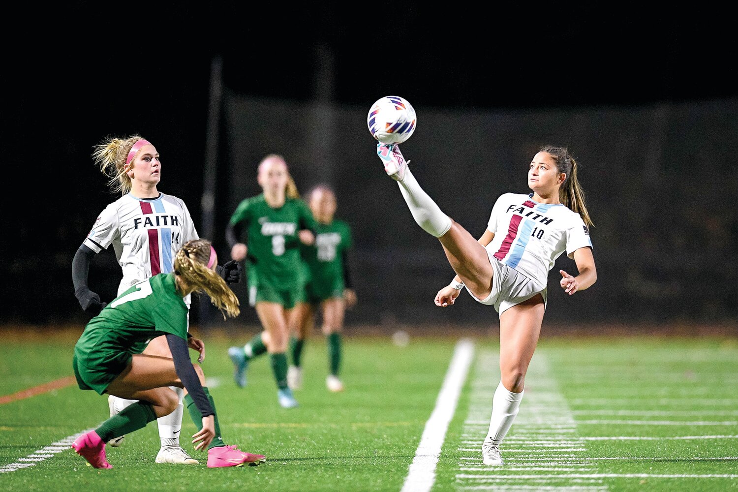 Faith Christian’s Brooke Picciotti extends to control a loose ball at midfield.