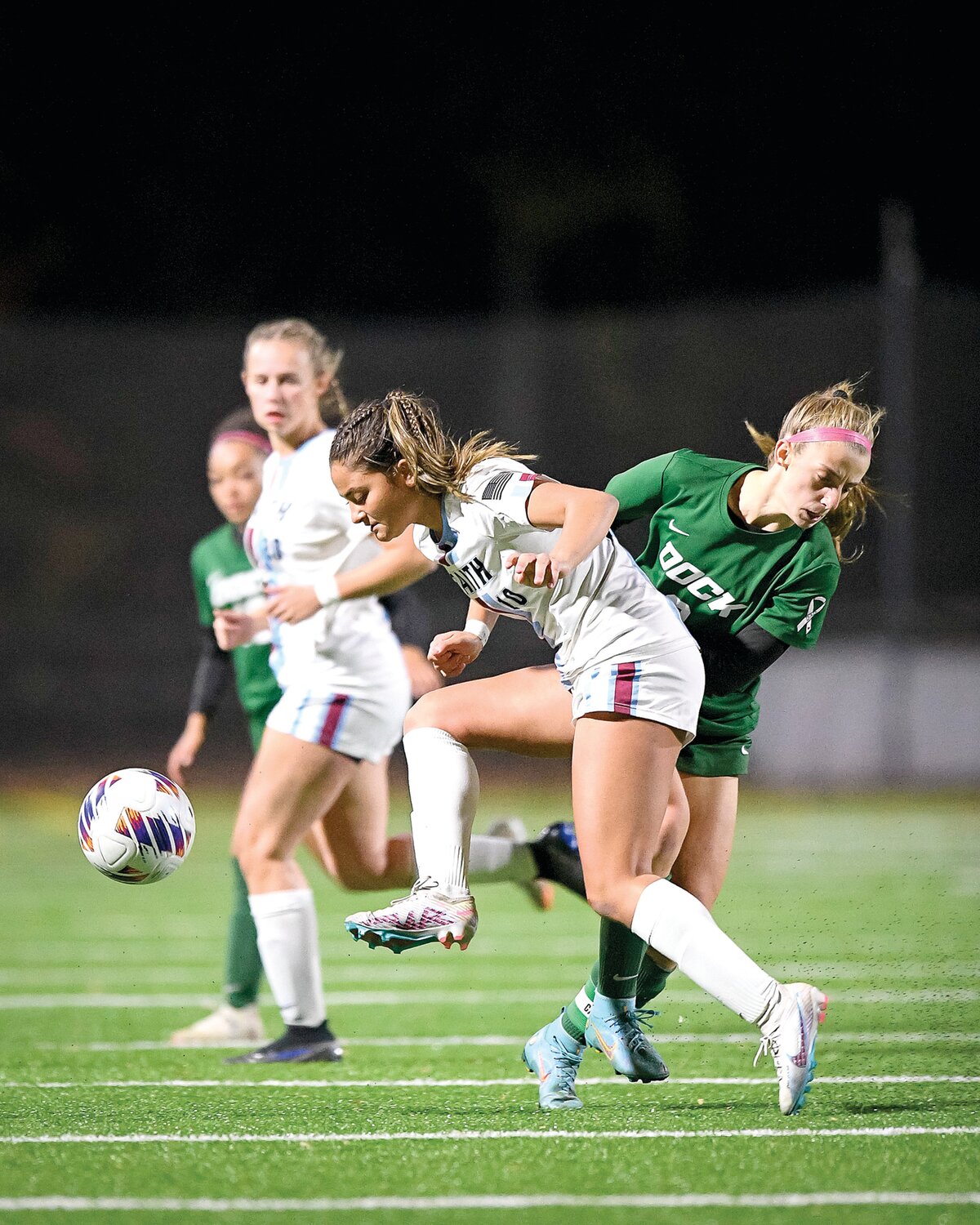 Faith Christian’s Brooke Picciotti and Dock Mennonite’s Billinda Leisner collide at midfield going after a loose ball.