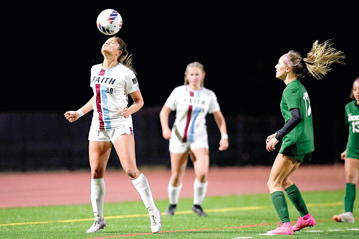 Faith Christian’s Brooke Picciotti redirects a header during the first half.