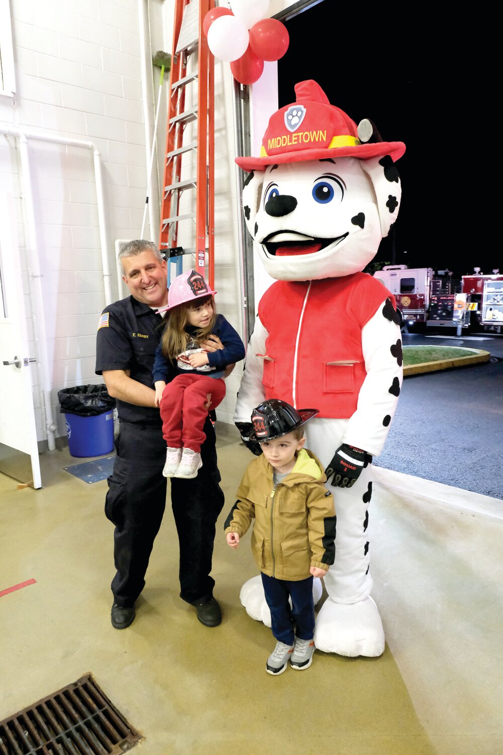 Fire Chief and PA Senator Frank Farry poses with his children and Marshall from PAW Patrol.