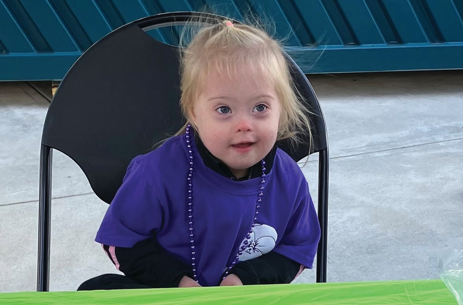 Violet Anastasi, 3, mans her table at the Buddy Walk to raise money for Children’s Hospital of Philadelphia’s clinic for people with Down syndrome.