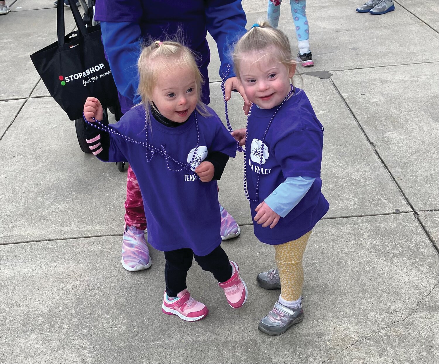 Violet Anastasi, left, and her friend Sadie Rollo, 3, of Monmouth County N.J., wait for the start of the Oct. 8 Buddy Walk at Lincoln Financial Field.