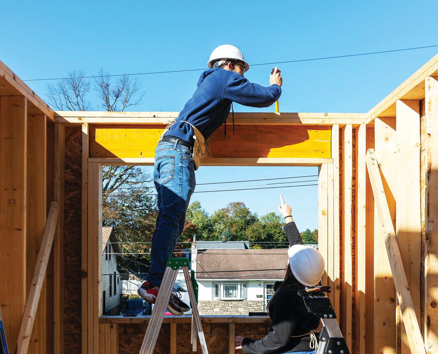 Volunteers Devon Laidler and Kristina Van Hart work on the house in lot No. 1 at Habitat for Humanity of Bucks County’s build site in Croydon.