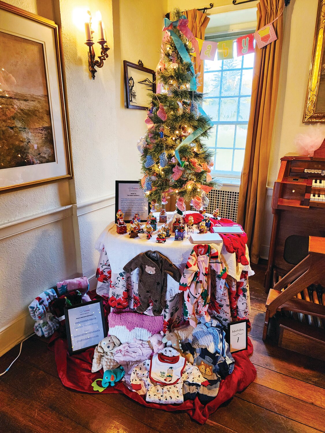 This display by The Baby Bureau is located in the living room by the organ.