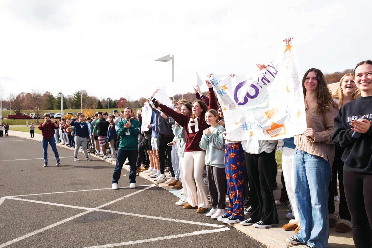 Pennridge High School students cheer on the Rams as their bus departs the high school in Perkasie for Eagle View Middle School in Mechanicsburg, where the PIAA soccer championships were played on Friday.