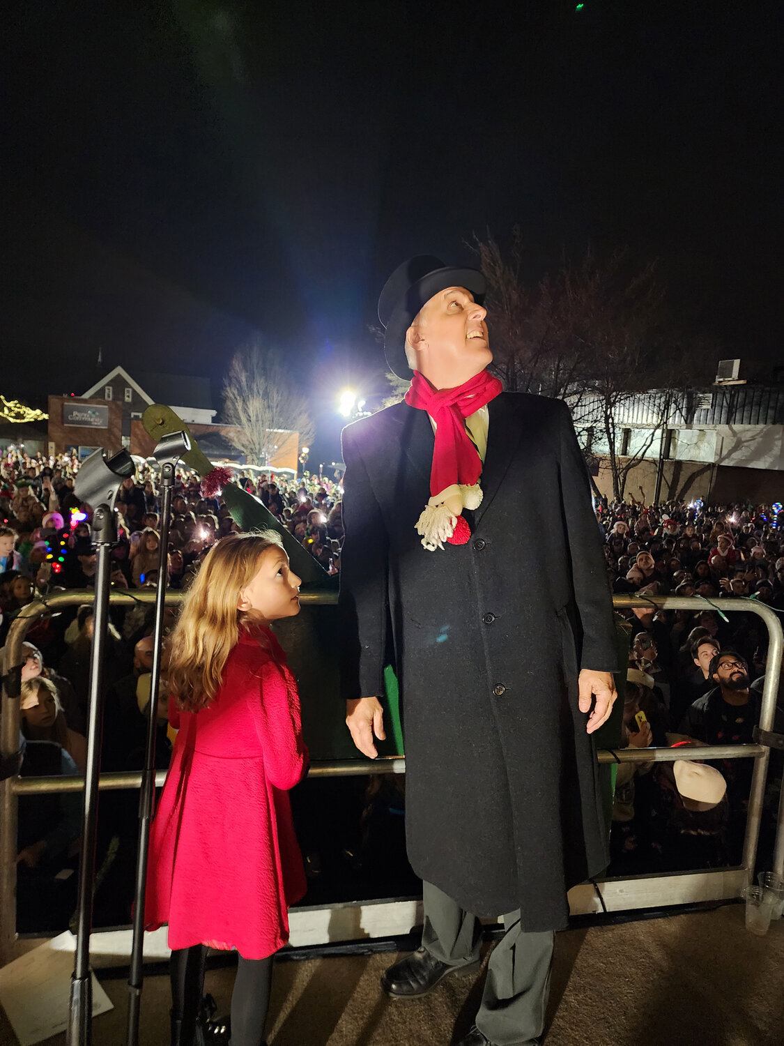 Perkasie Mayor Jeff Hollenbach with Lenna Rivera gaze at the tree just after pulling the lever to light it.