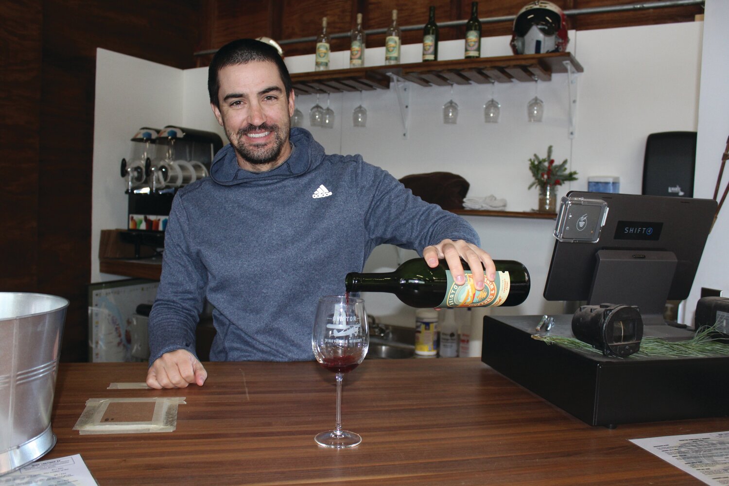 Aviator Winery wine-maker and Central Bucks High School East math teacher Chris Burns pours a tasting sample.