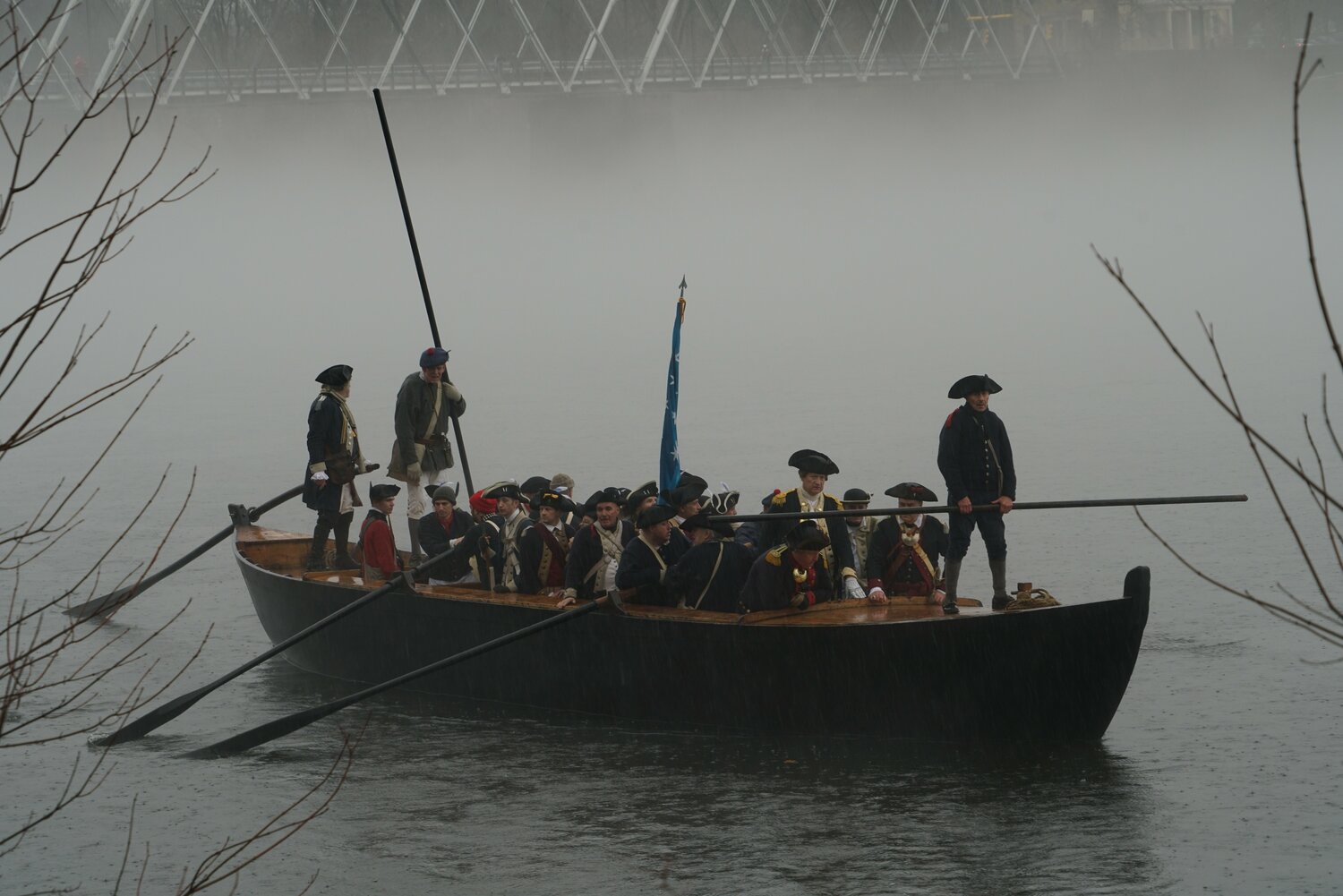 Through fog and misty rain, a Durham boat heads for shore during Sunday’s reenactment of Washington’s famous Delaware River crossing.