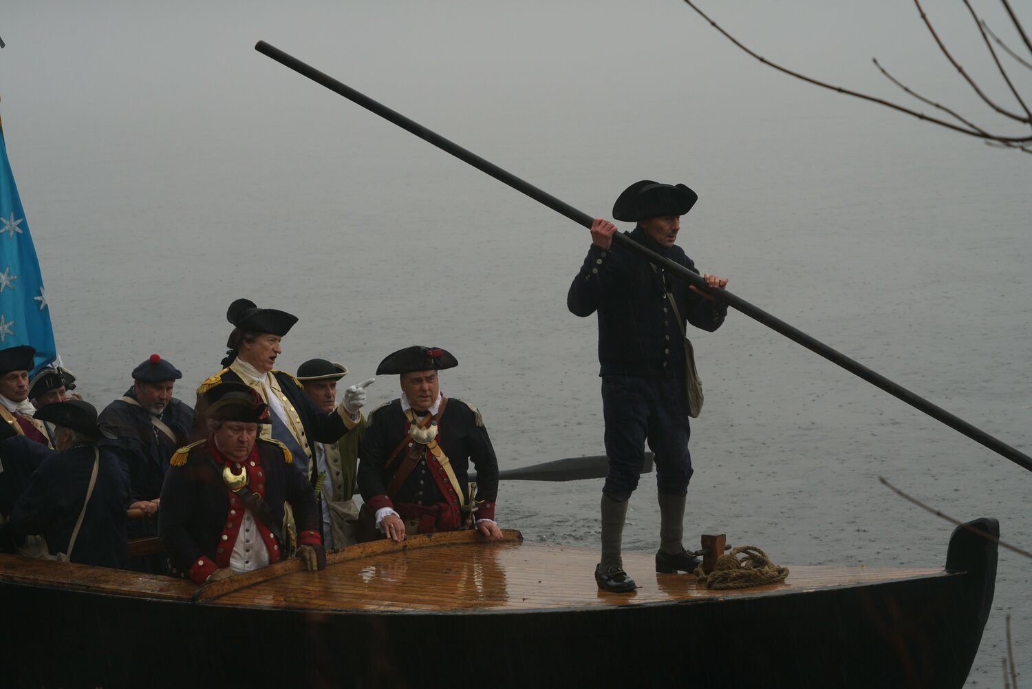 Reenactors row across the Delaware River in a Durham boat.