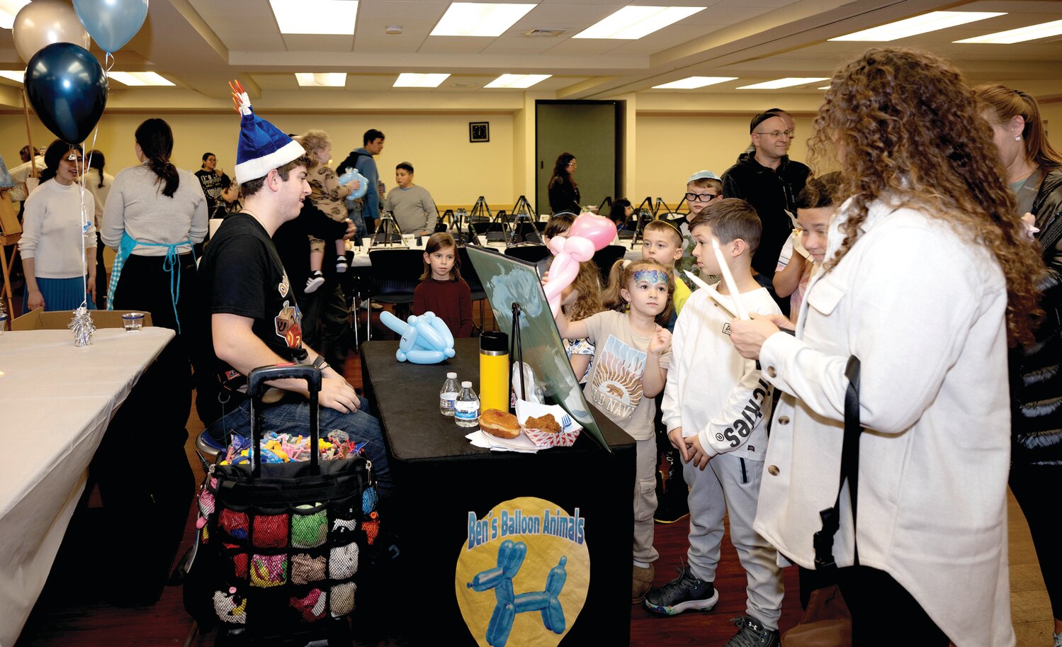 Balloon artist Ben Richlin makes dreidels and other creations for kids.