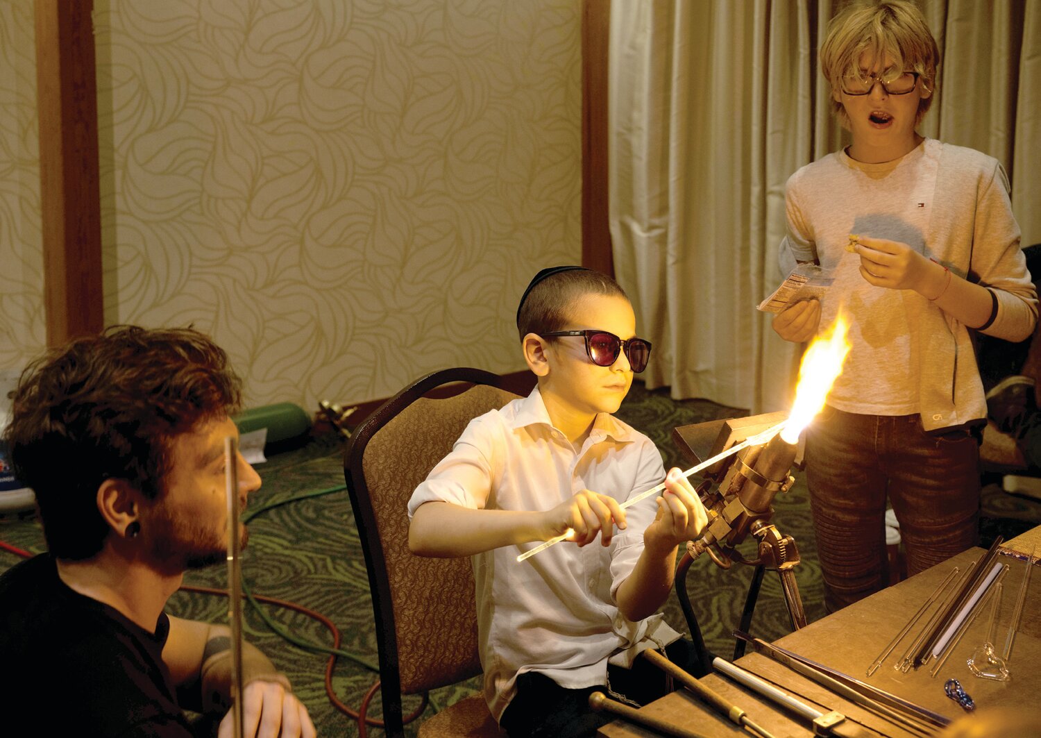 Attendees participate in a glass-blowing activity at the Family Chanukah Celebration in Newtown Dec. 10.