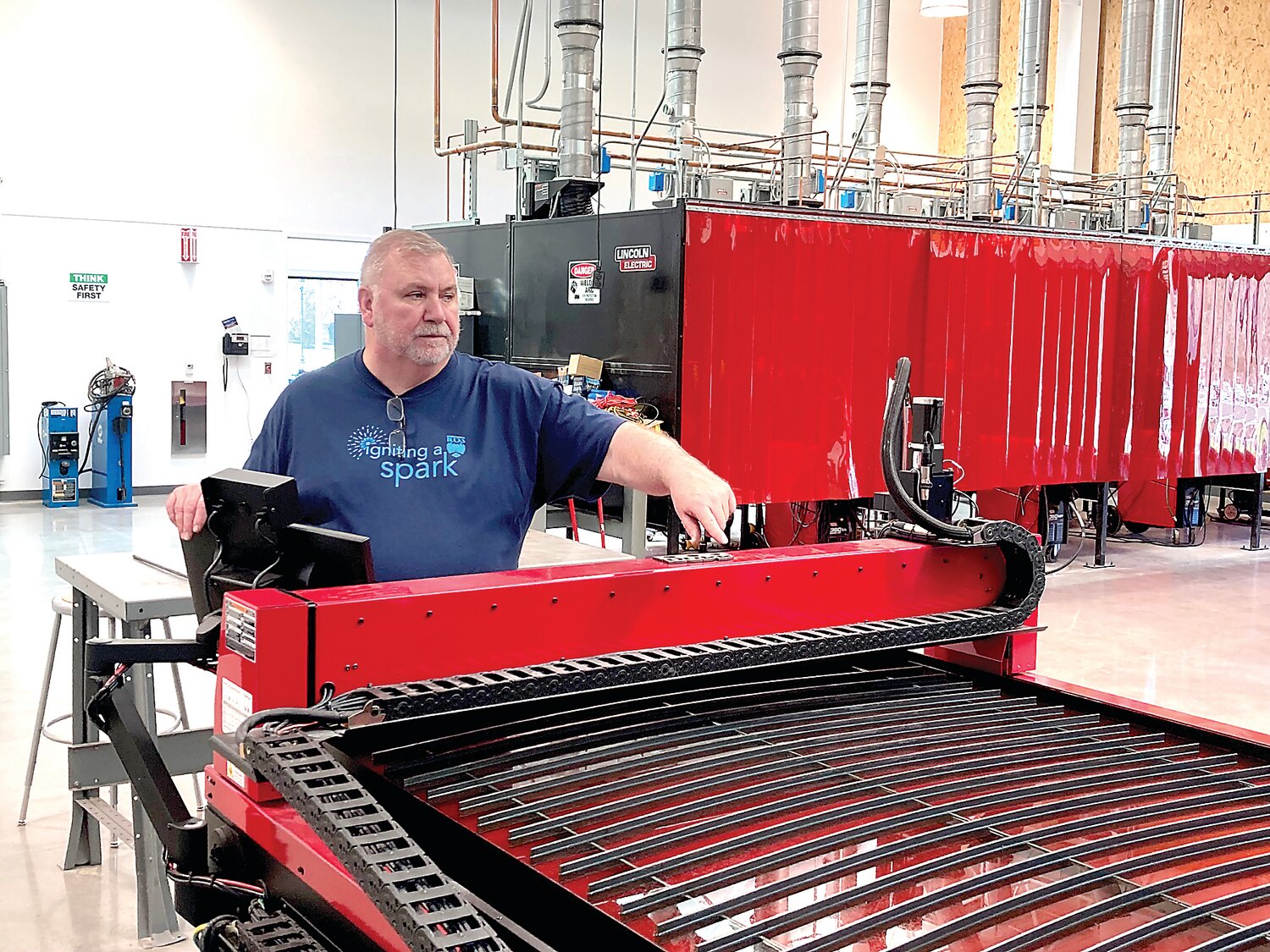 Bucks County Community College instructor Joe Coates shows off a giant plasma table that can produce all kinds of metal shapes at BCCC’s new Center for Advanced Technologies in Bristol Township.