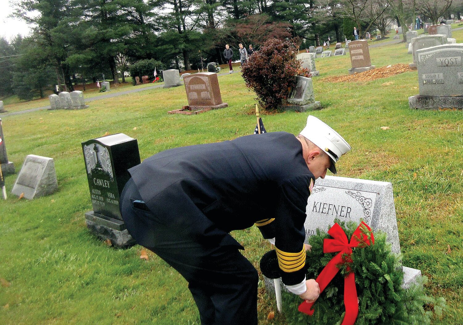 Adam Selisker places a wreath at the Kiefner headstone.