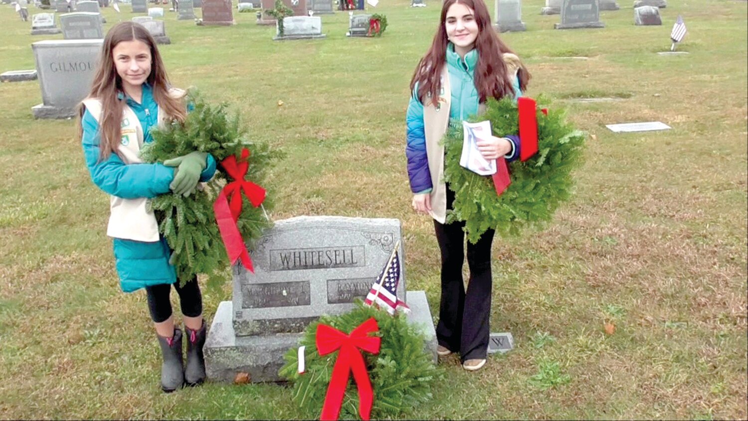 A pair of Girl Scouts help place wreaths at graves in Union Cemetery.