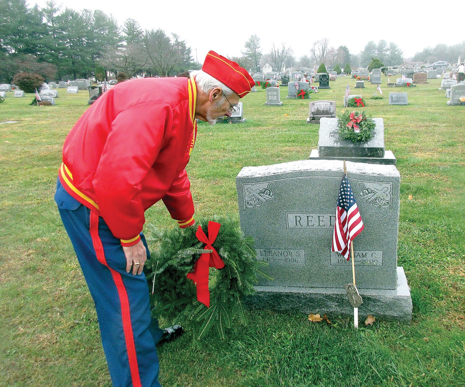 Pete Palestina places a wreath at the Reef headstone.