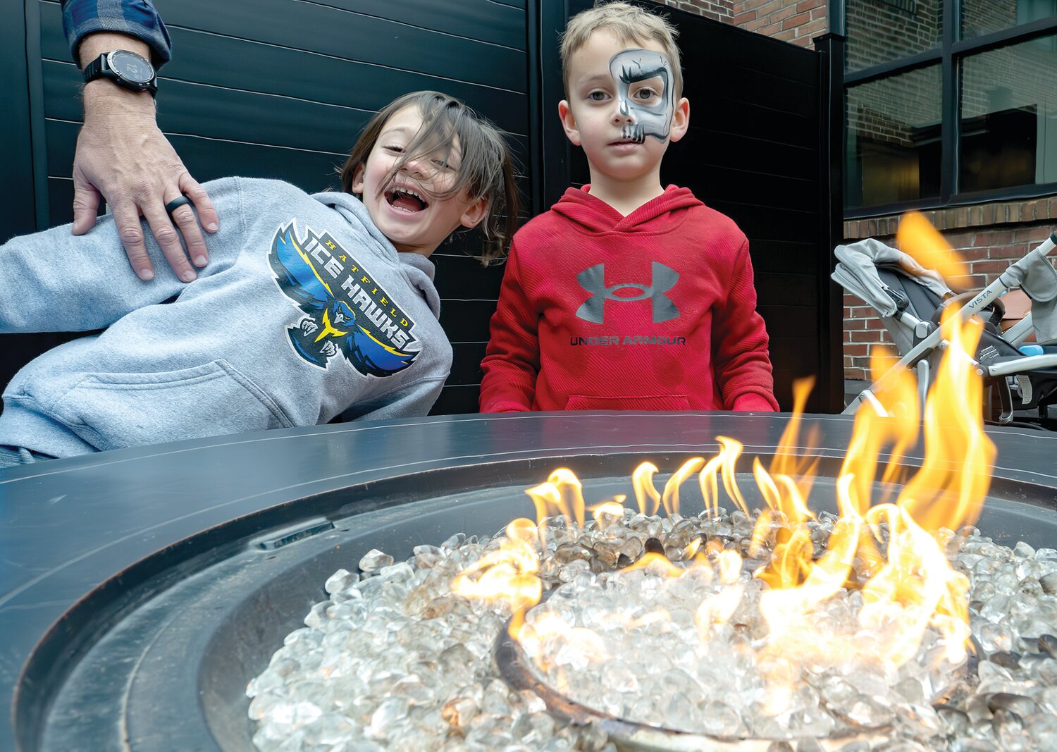 Logan and Jake Sadowski enjoy the warmth of the fire.