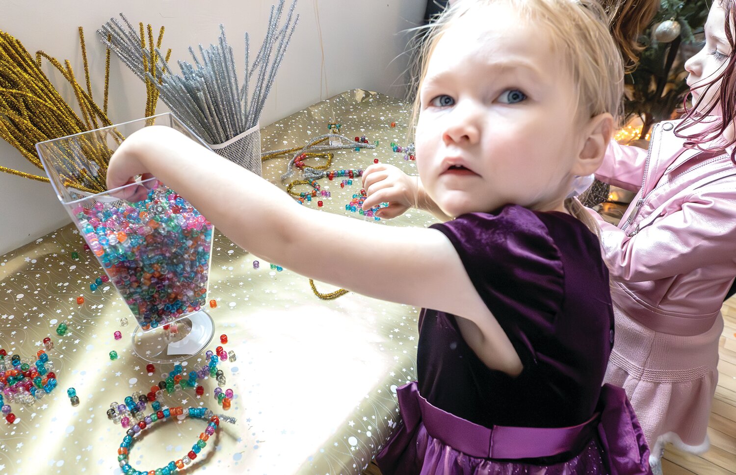 June Rimmer celebrates “Noon Year’s Eve” making jewelry after the balloon drop.