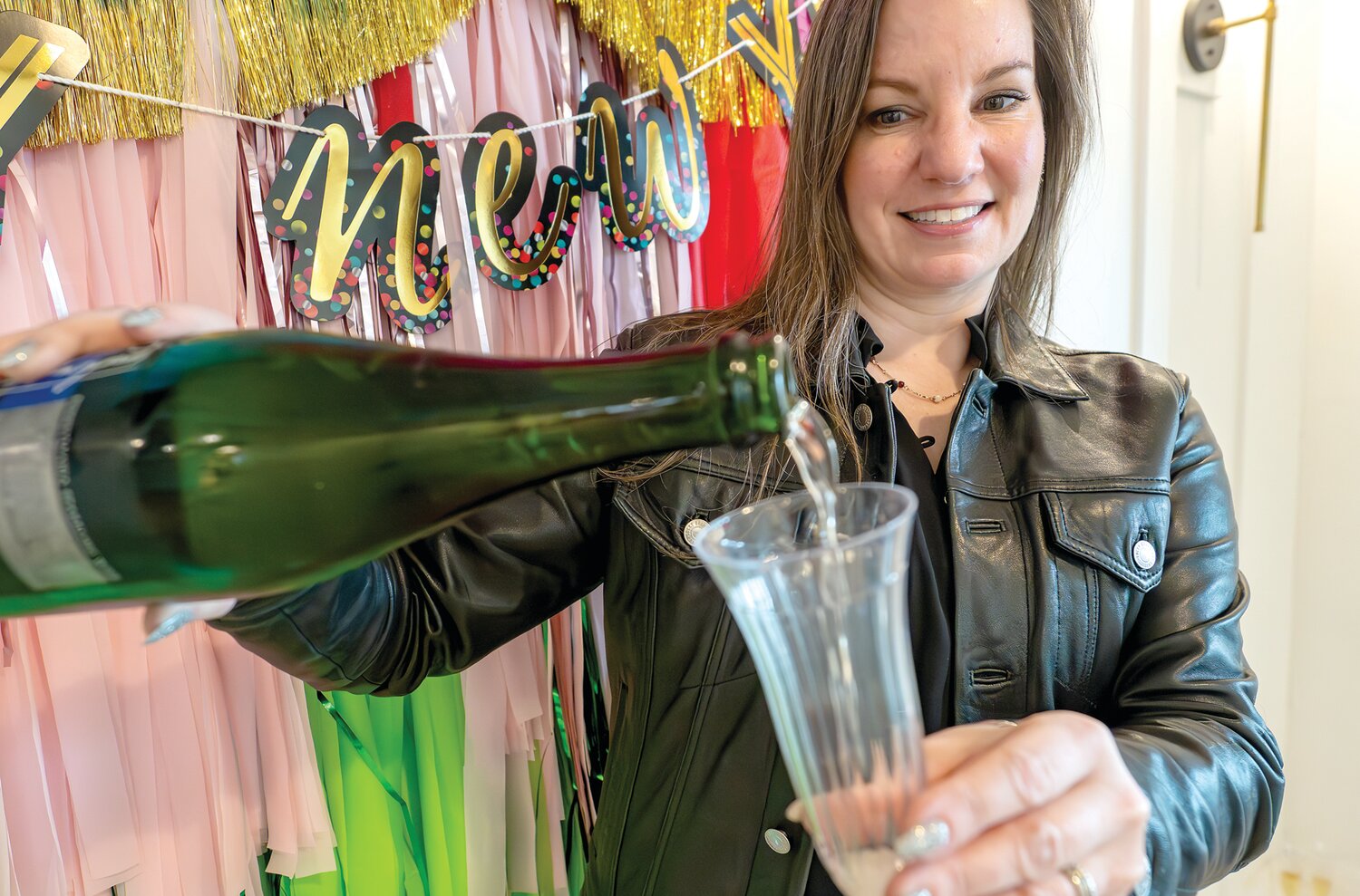 Event organizer Kathy Safi, owner of Pineapple on Main and Confetti, pours a glass of Champagne for guests.